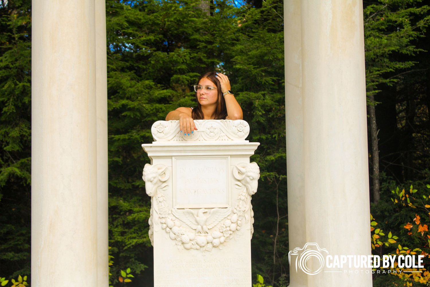 This is a picture of a girl leaning on a statue