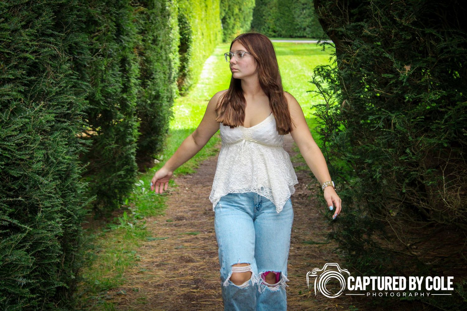 This is a picture of a girl walking on a dirt path