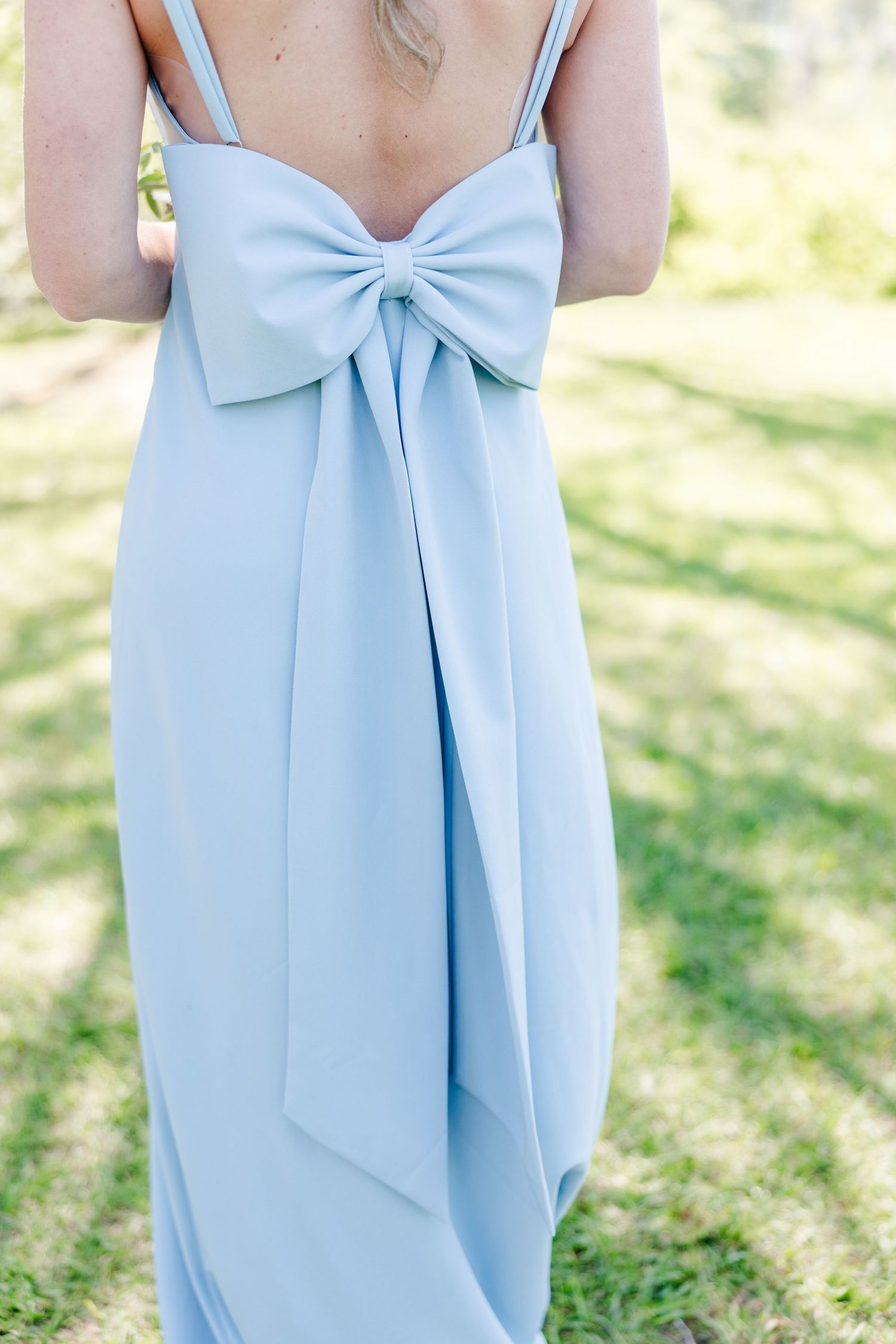 Light blue bridesmaid dress details showing elegant bow design on the back.