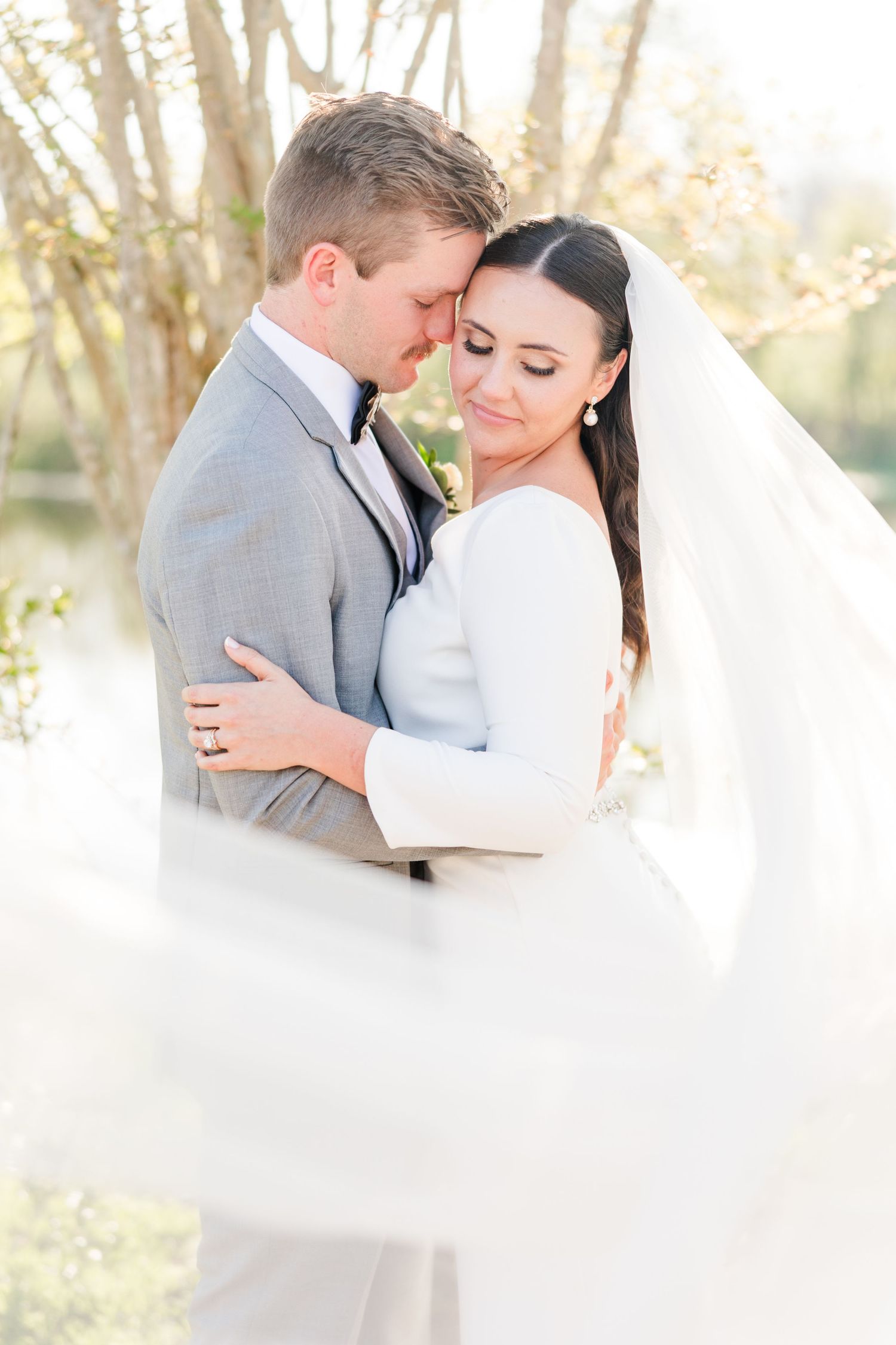 Ethereal wedding portraits with dreamy backlit natural lighting.