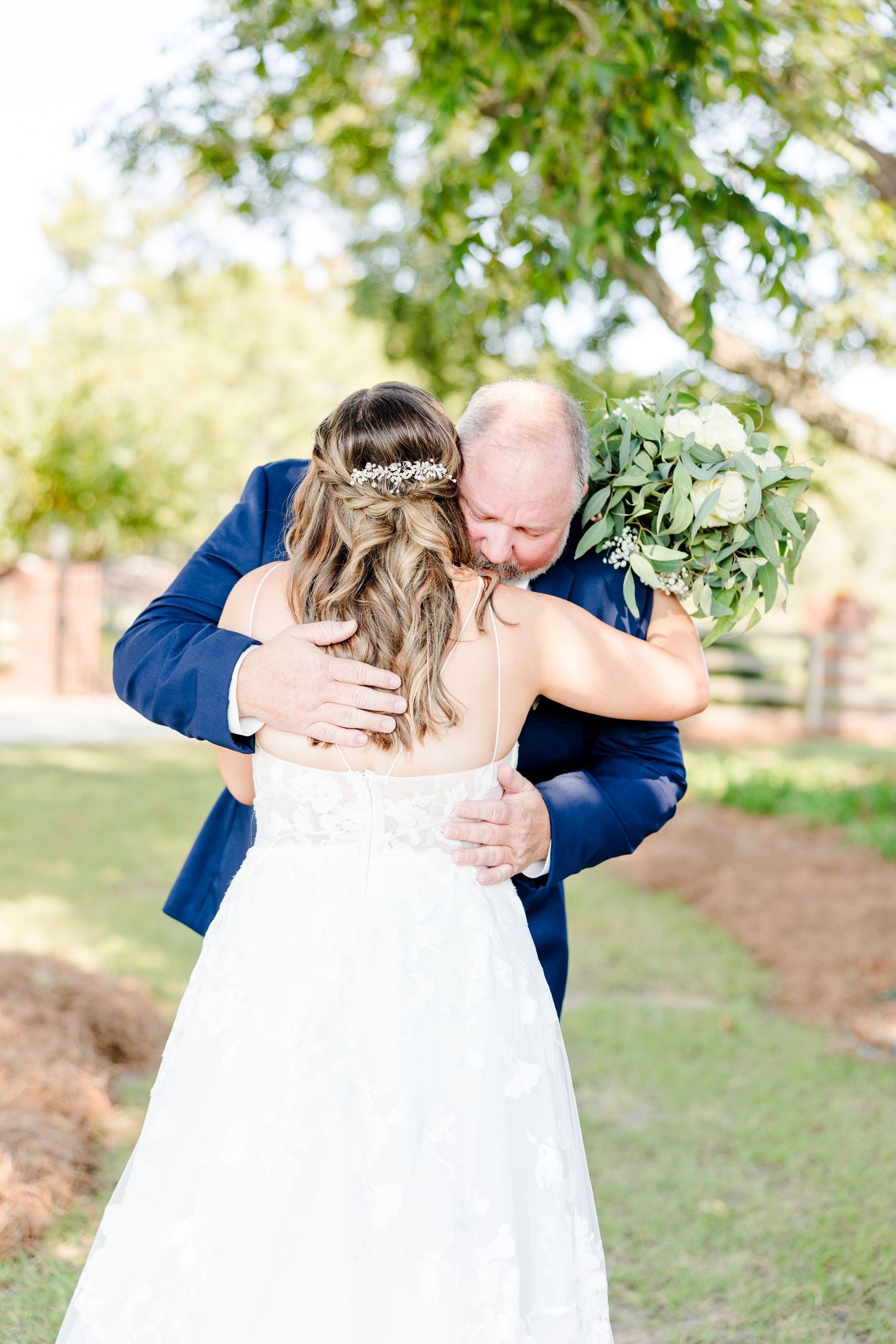 Emotional wedding first look sequence showing tender embrace in garden setting.