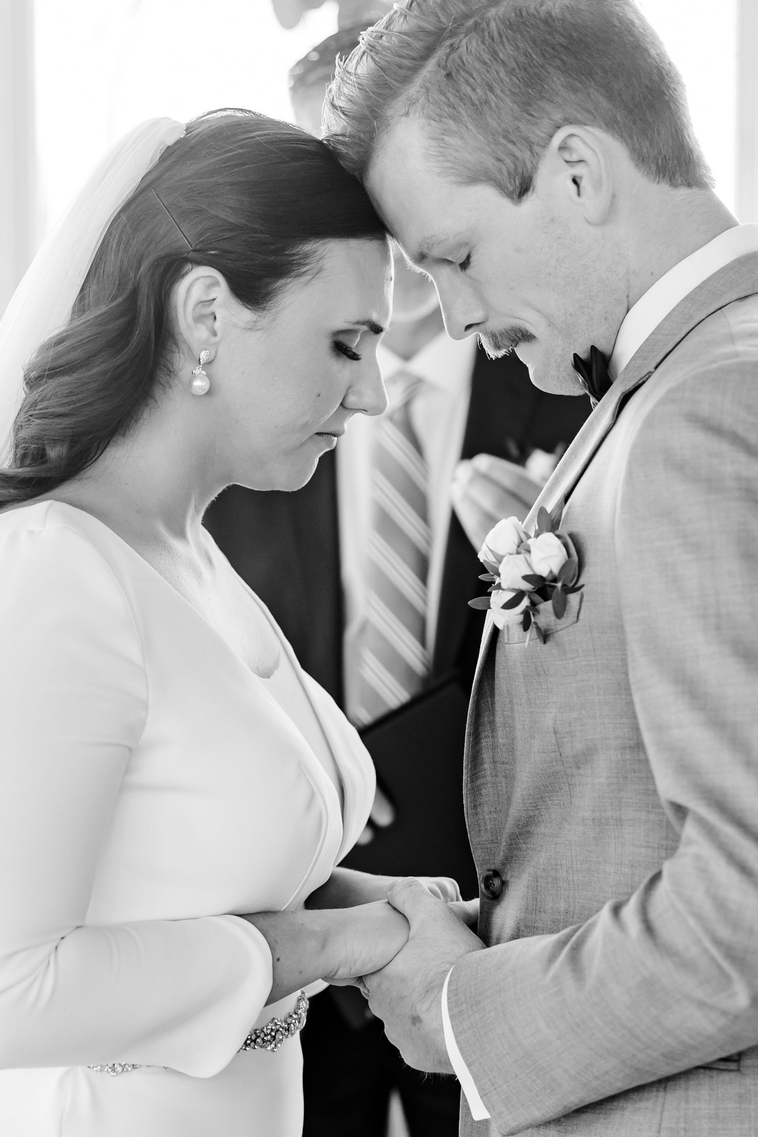 A tender black and white moment shared between a couple during their wedding ceremony.