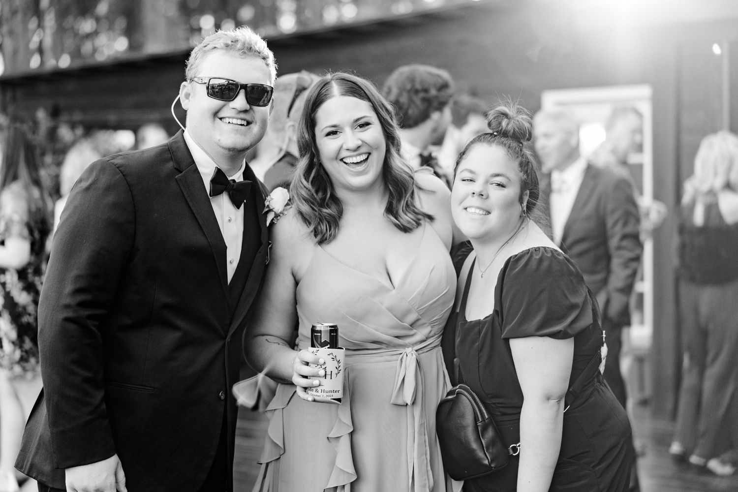 Black and white photo of wedding guests enjoying reception celebrations.