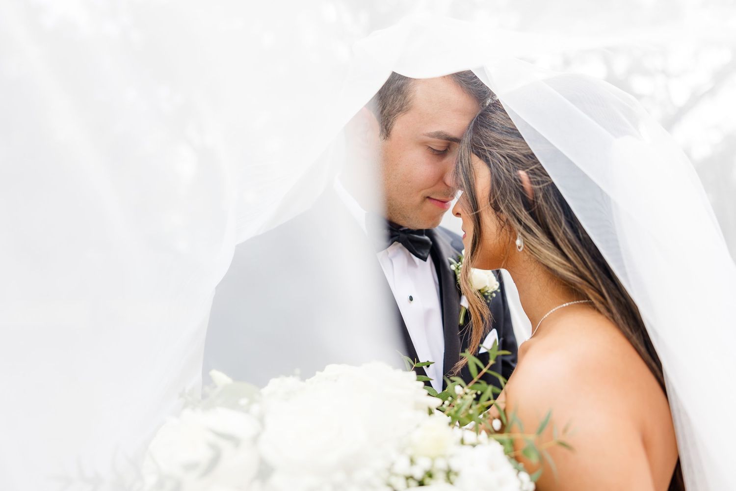 Close-up wedding portraits showing intimate moments with flowing white veil.