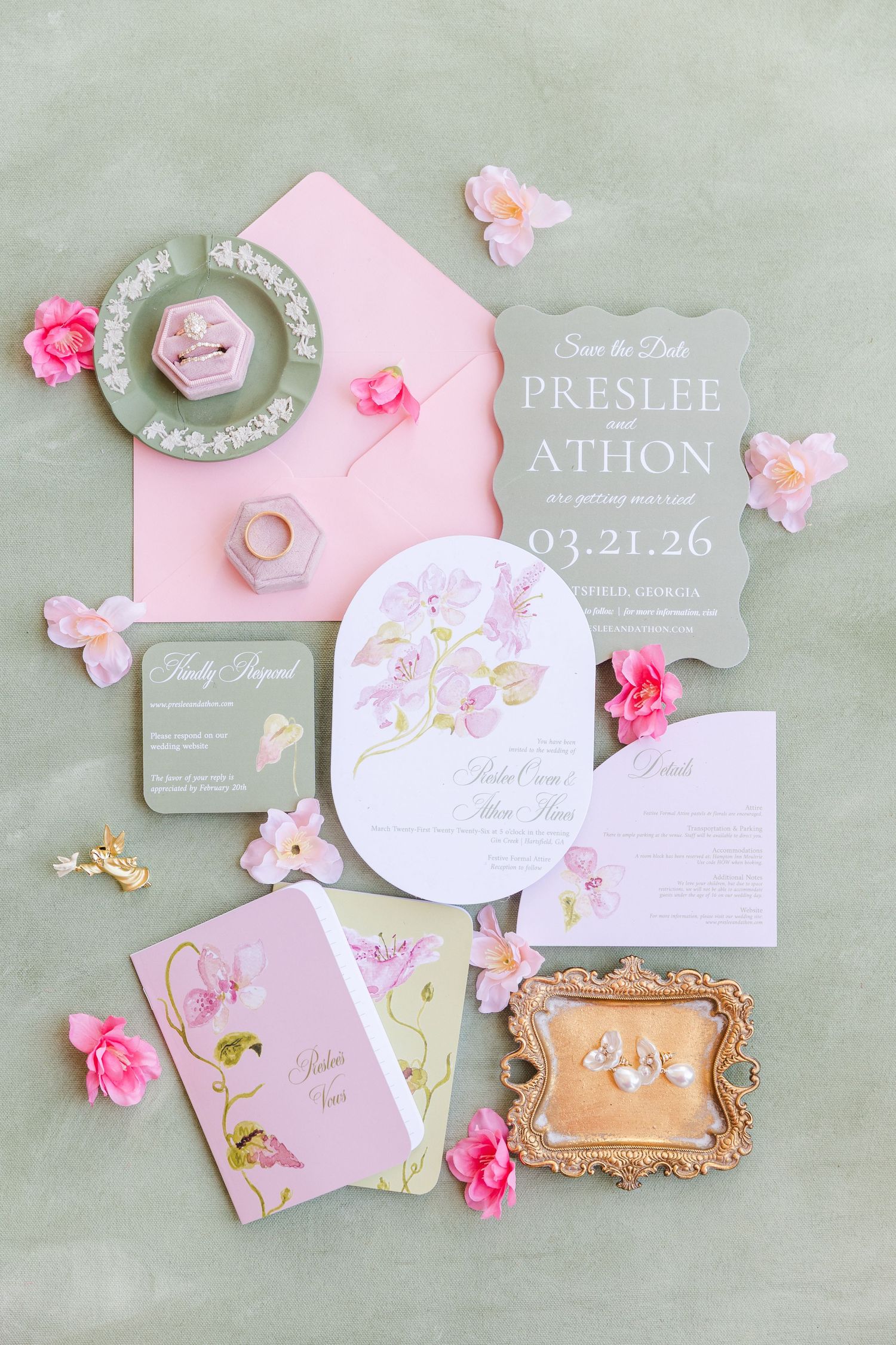 Elegant wedding invitation suite in pink and green with floral details, save the date card, and ring boxes on sage background.