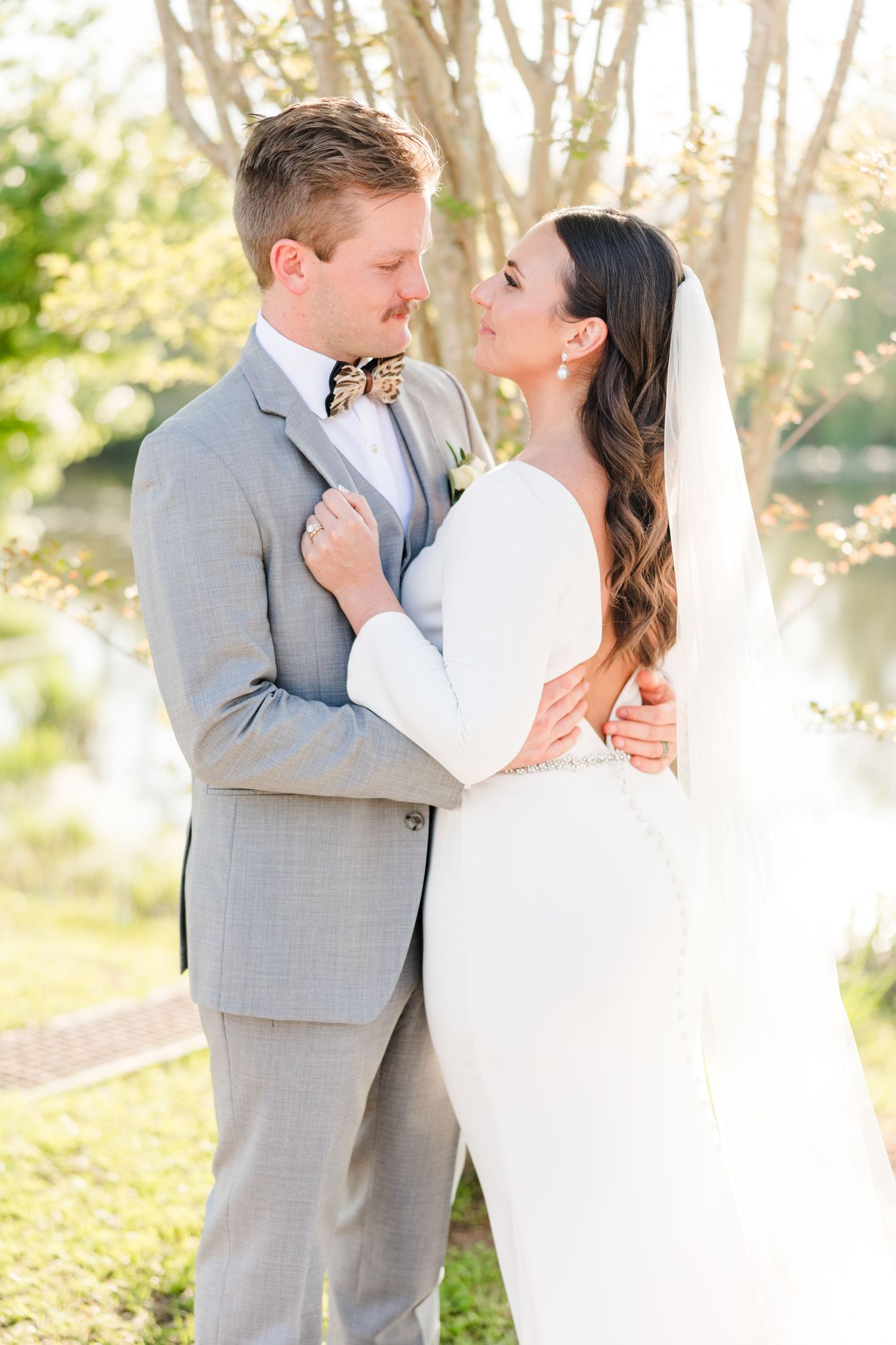 Romantic wedding couple shares intimate moments in a sunlit garden setting with soft natural lighting.