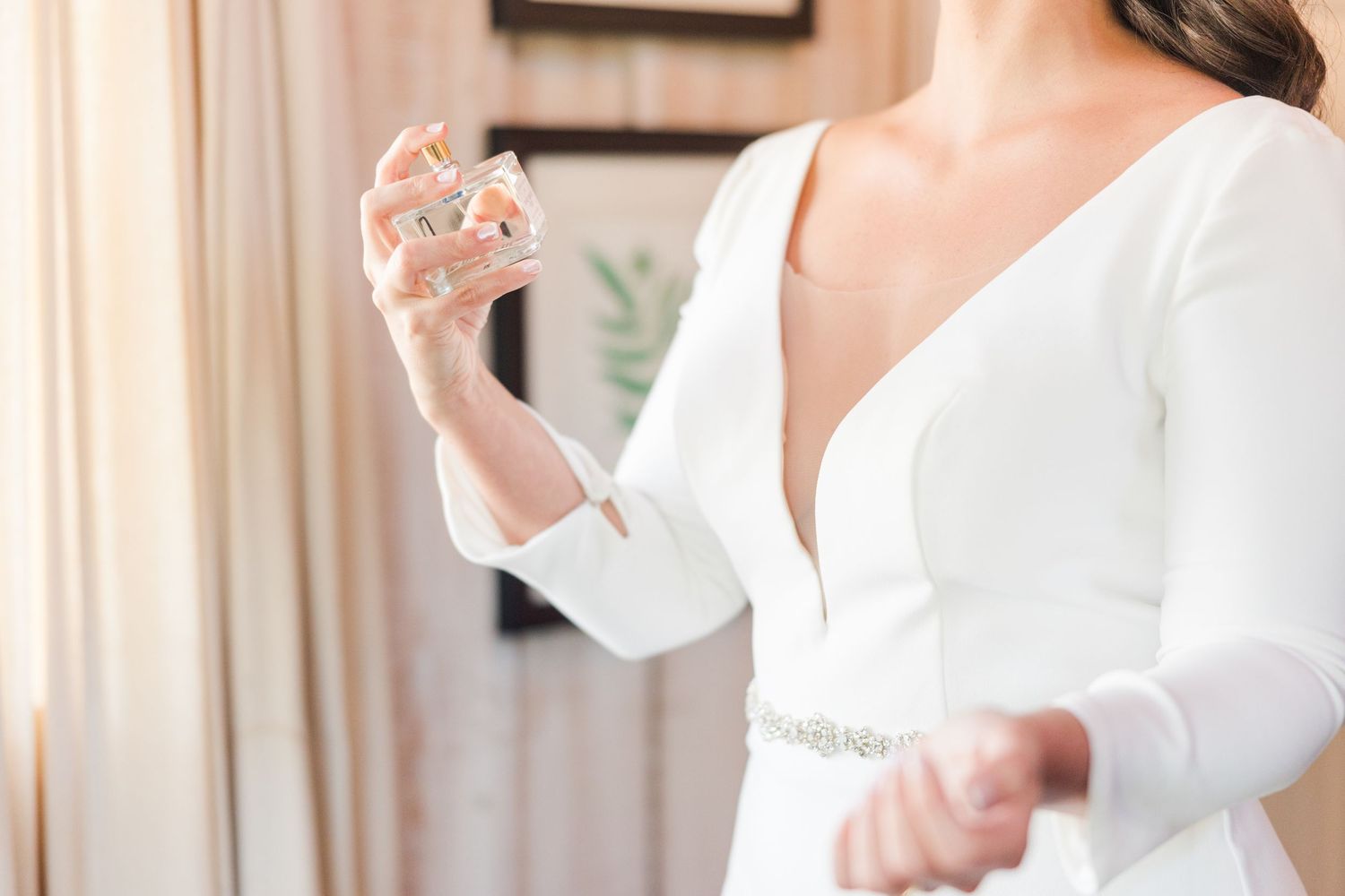 Elegant getting ready scene with white silk robes and champagne flutes.