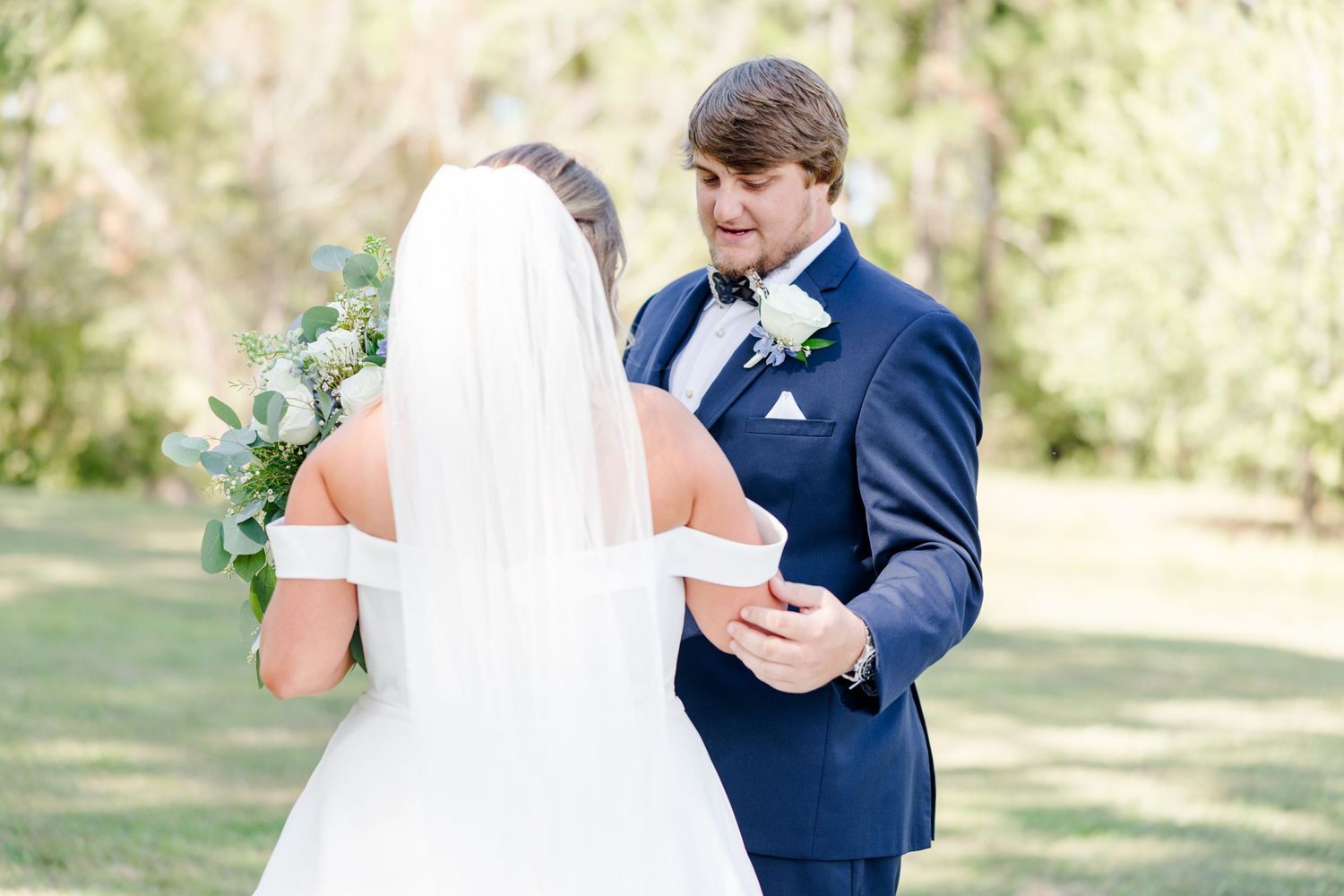 Romantic first look moment between bride and groom on their wedding day.