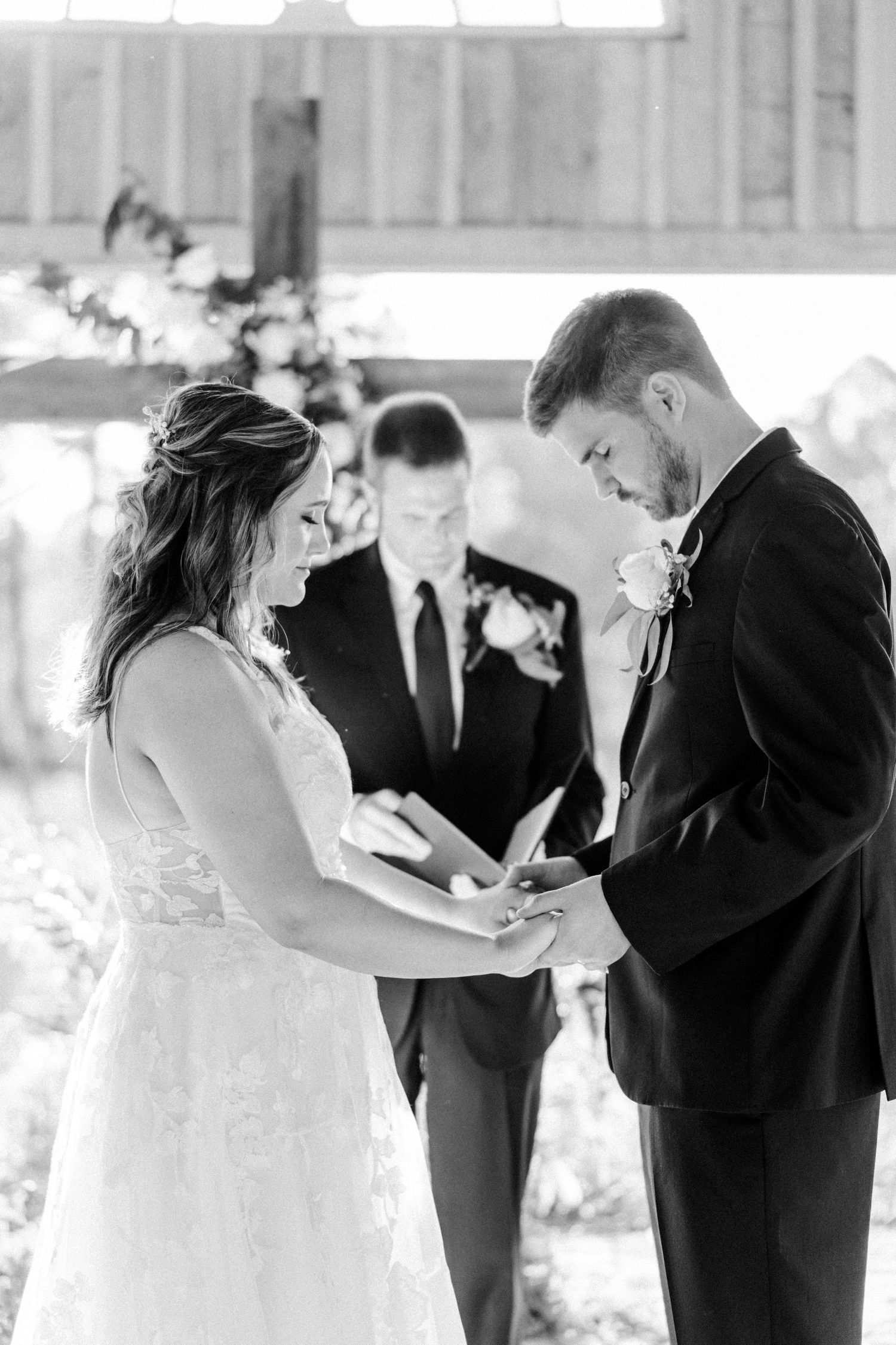 Black and white photos of a wedding ceremony in a rustic venue.