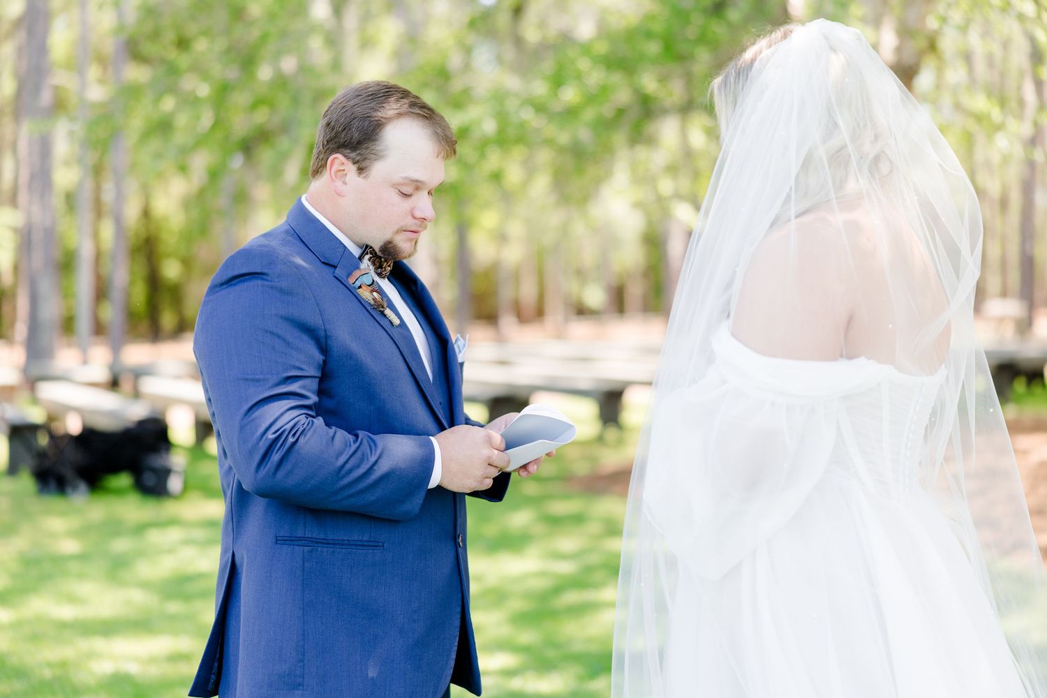 Emotional wedding first look scene in a sunlit garden setting.