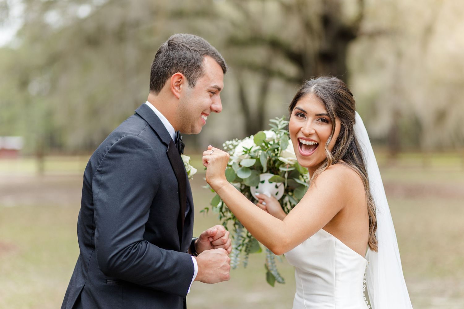 A joyful wedding couple shares a candid moment during their outdoor photo session.