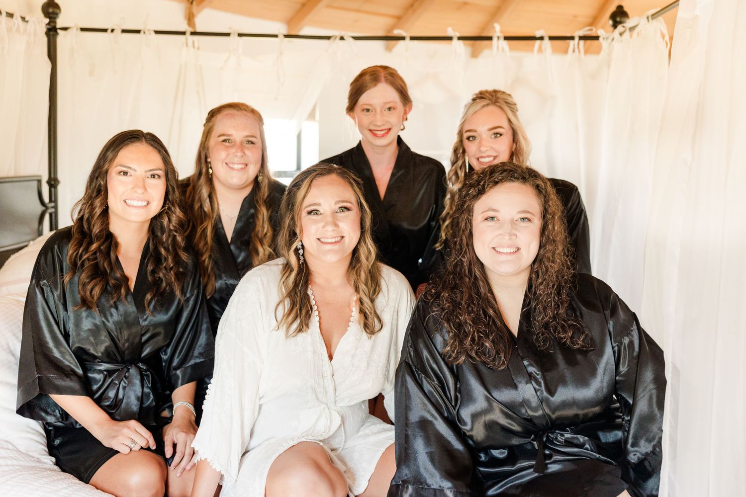 Wedding party getting ready in matching black and white robes.