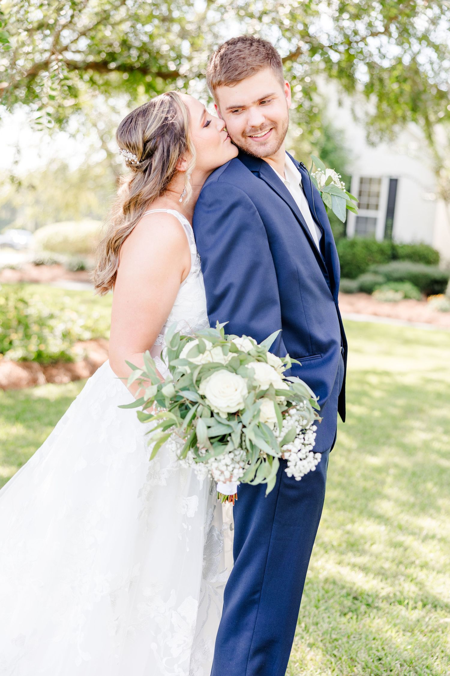 Intimate wedding photography captures sweet moments between couple in garden setting.