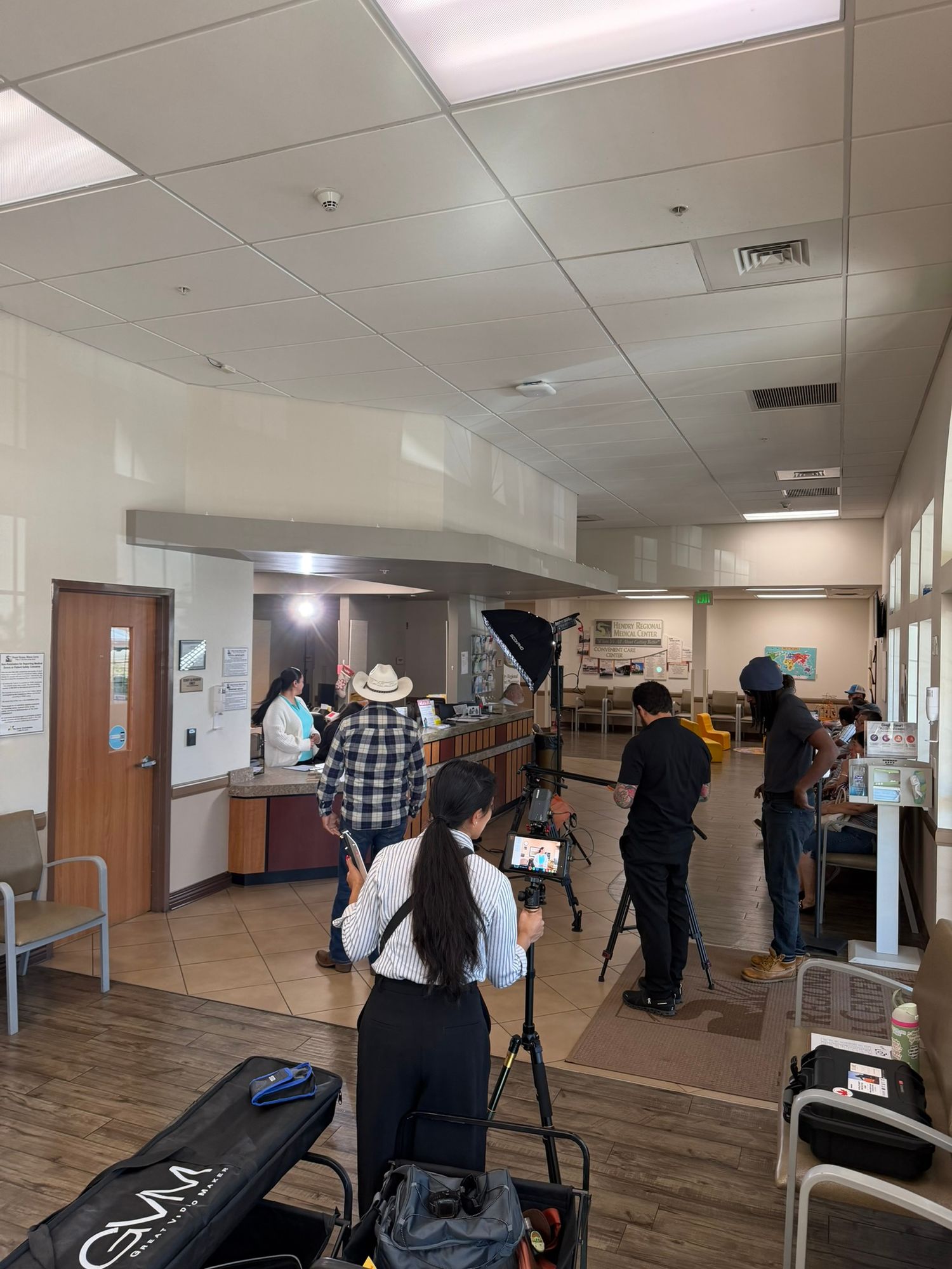 Yshia Films' team setting up professional lighting and video equipment inside a medical office lobby.