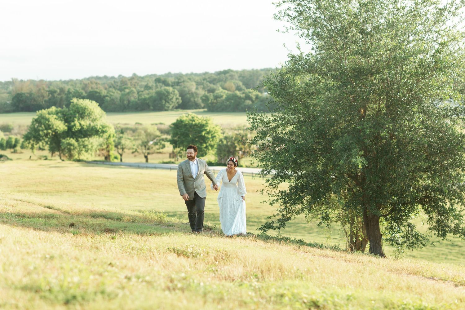 Intimate sunrise elopement at Celery Fields in Sarasota, FL, with a couple exchanging vows in golden light atop the peaceful, misty hilltop.
