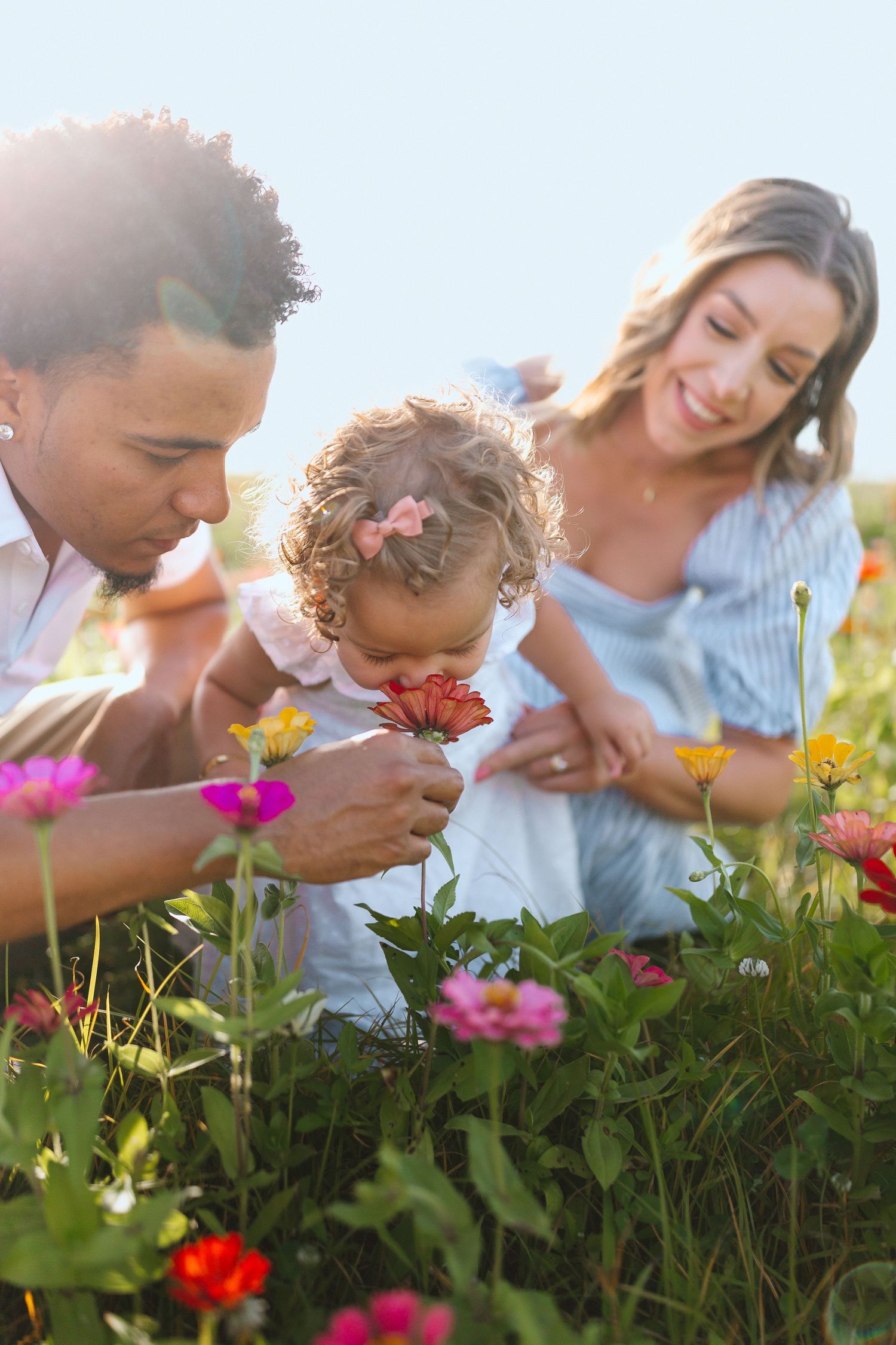 Spring family session at Hunsader Farms in Bradenton, FL, with golden sunset light, blooming fields, and joyful moments captured among the