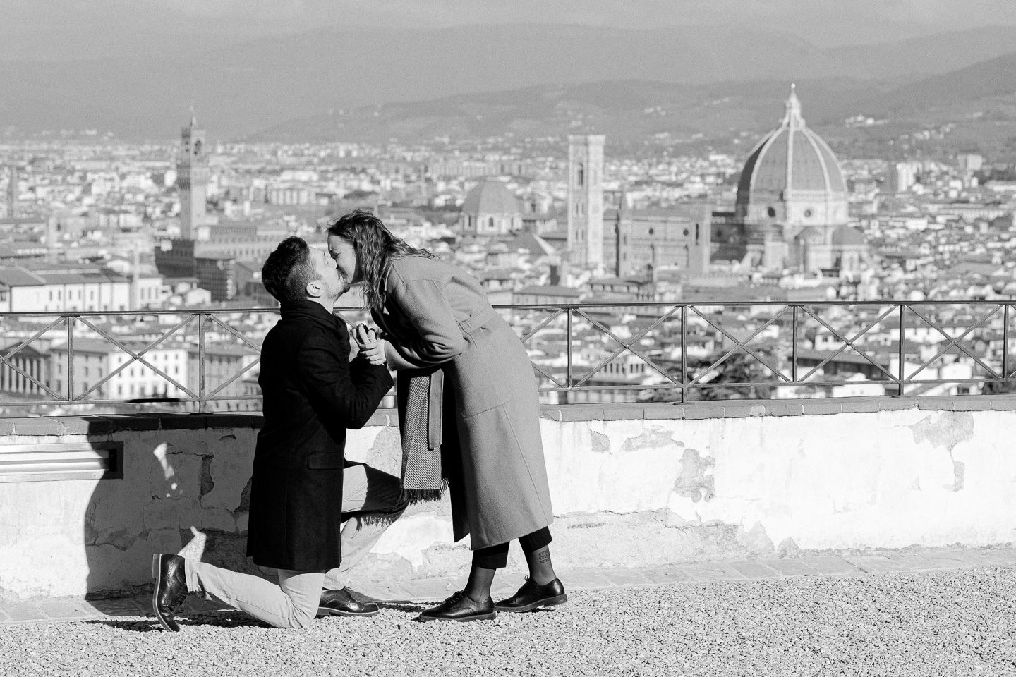 Man on one knee proposing to his girlfriend, during an engagement and proposal photoshoot on the terrace of San Miniato al Monte, Florence