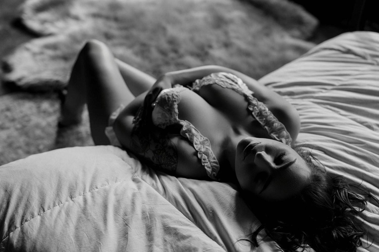 Black and white artistic photo sequence showing a person lying down and moving in a flowing motion through multiple frames.