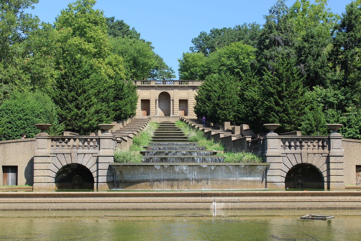 Ornate stone staircase with water fountains and classical archway leads to garden pavilion at Meridian Hill Park in Washington DC.