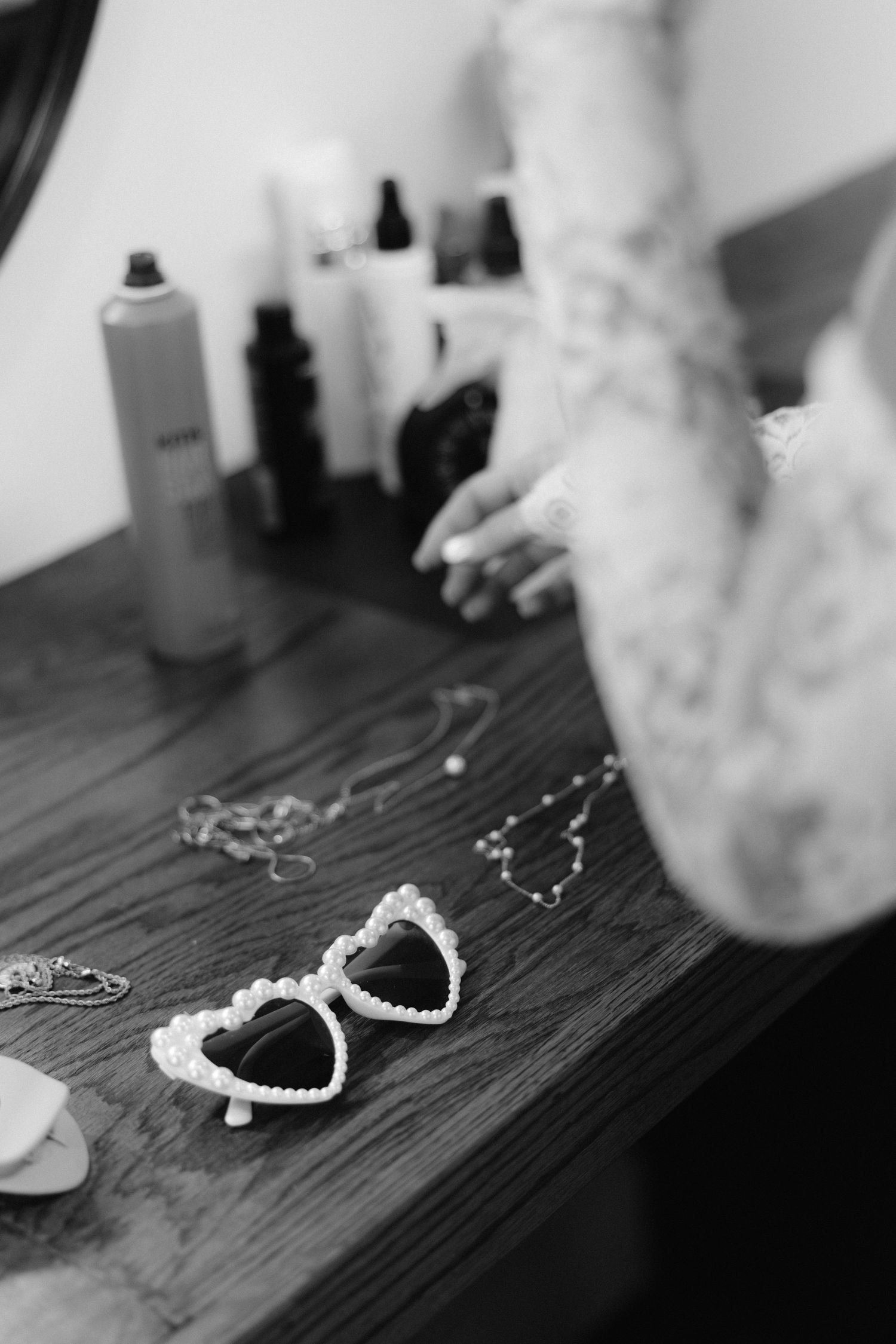A sequence of black and white photos showing handcuffs on a dark wooden surface.