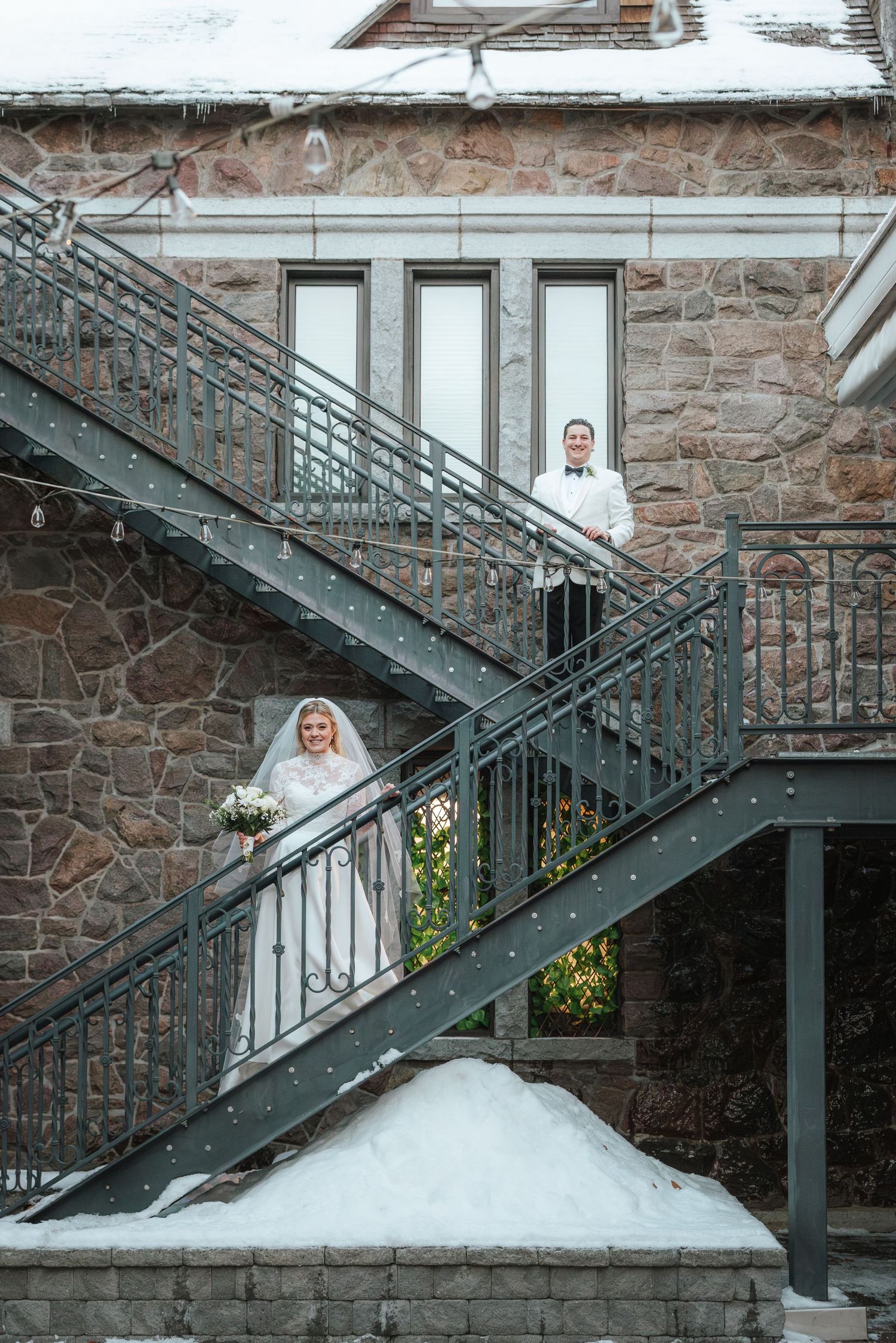 A series of photos showing a bride in a white wedding dress posing on an exterior stone staircase with metal railings.