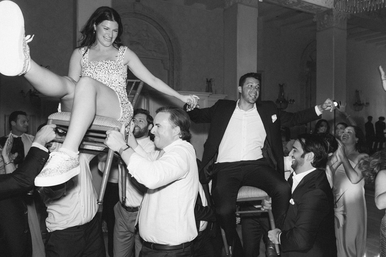 Vintage black and white photograph showing couples dancing together at a formal social gathering.