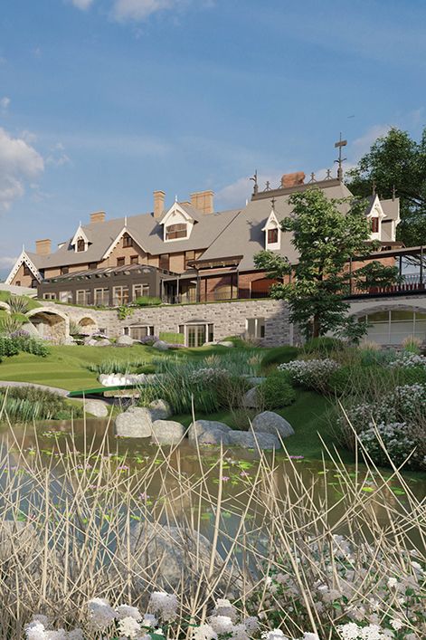 Elegant Tudor-style estate with stone retaining wall, arched bridge, and lush garden pond surrounded by wildflowers.