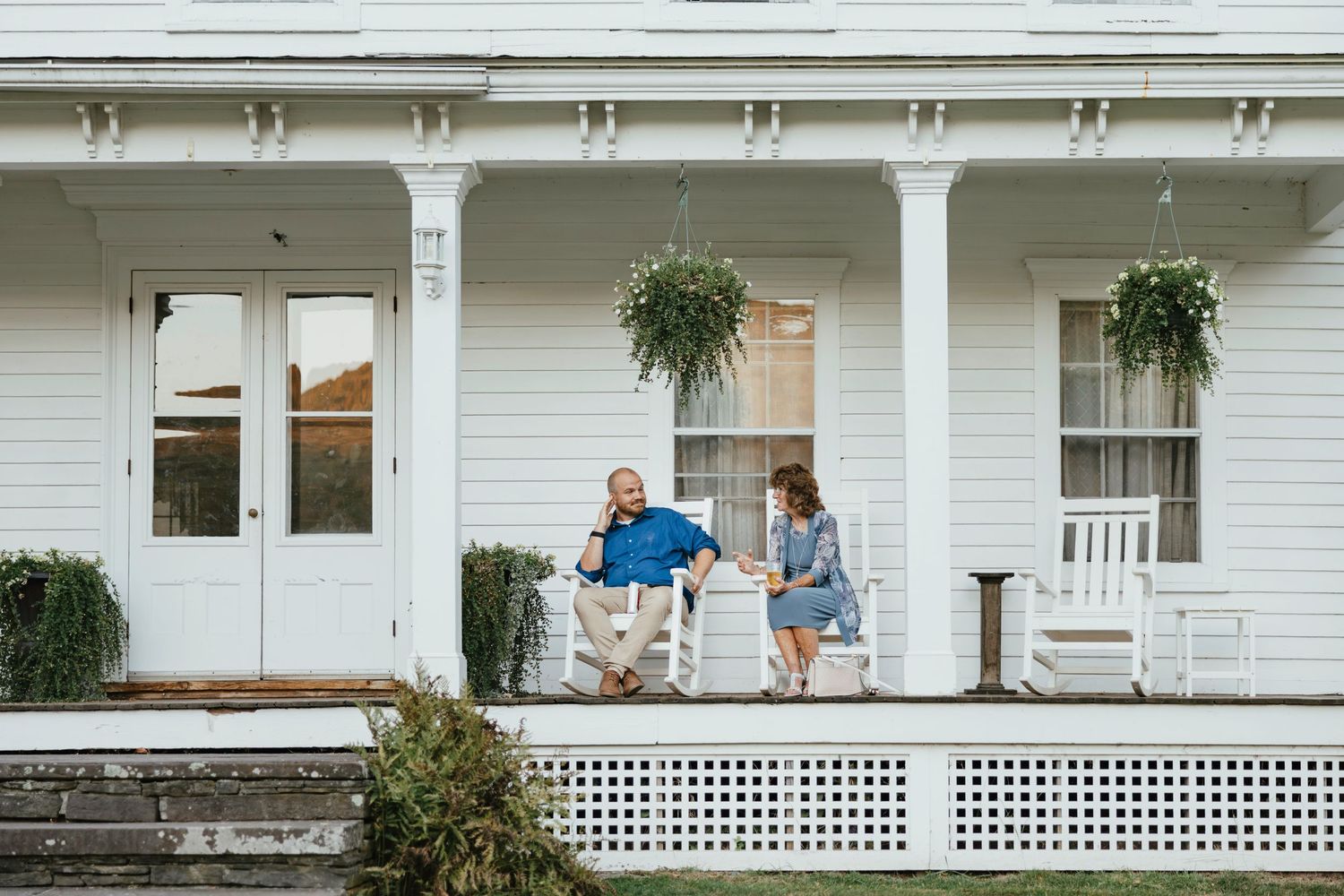 A series of white porch scenes with rocking chairs and lattice details creates a nostalgic Americana atmosphere.