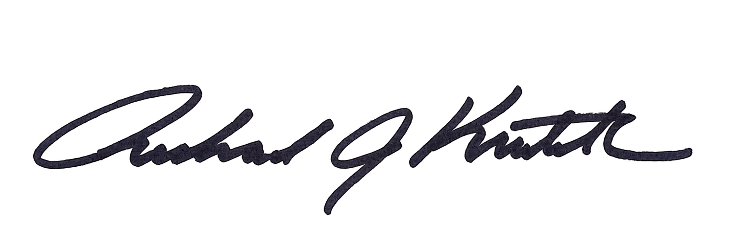 A cursive handwritten signature in dark ink on a white background.