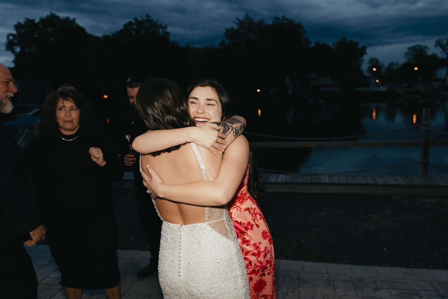 Two people dance together under moody evening skies at an outdoor event.