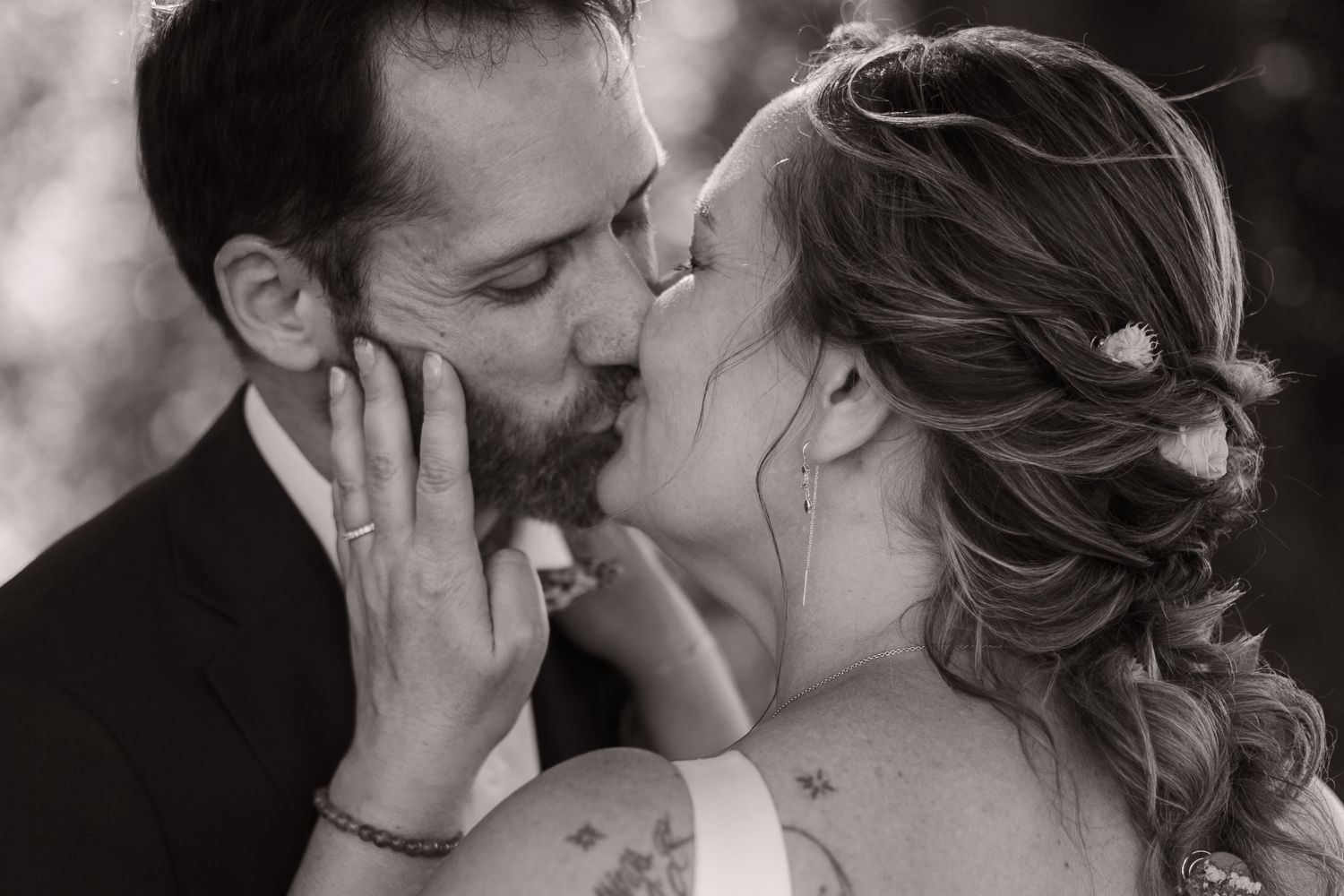 Black and white romantic wedding photographs showing intimate kiss moments between couples in various settings.