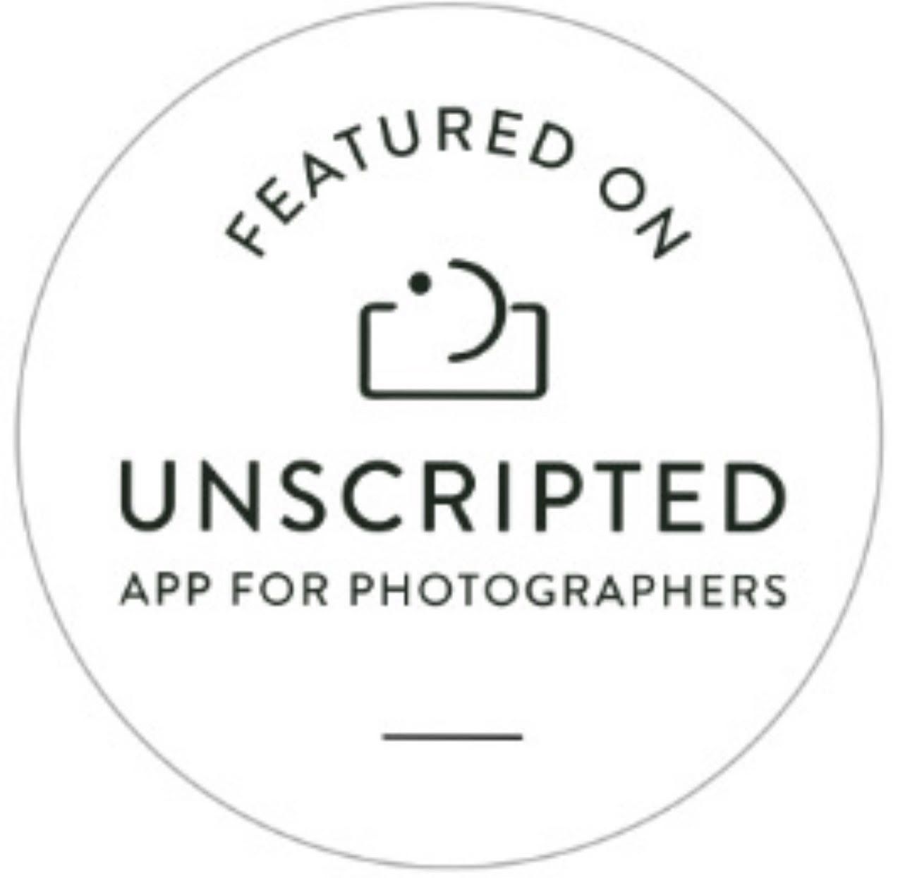A circular black and white logo for Unscripted App for Photographers featuring a minimalist camera icon.