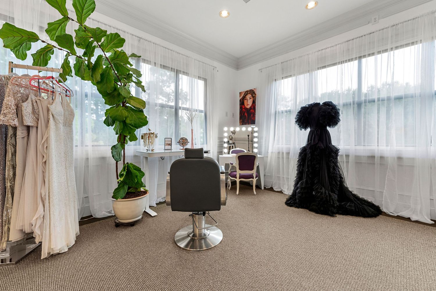 Elegant styling suite with vanity mirror, barber chair, sheer curtains, and decorative plant.