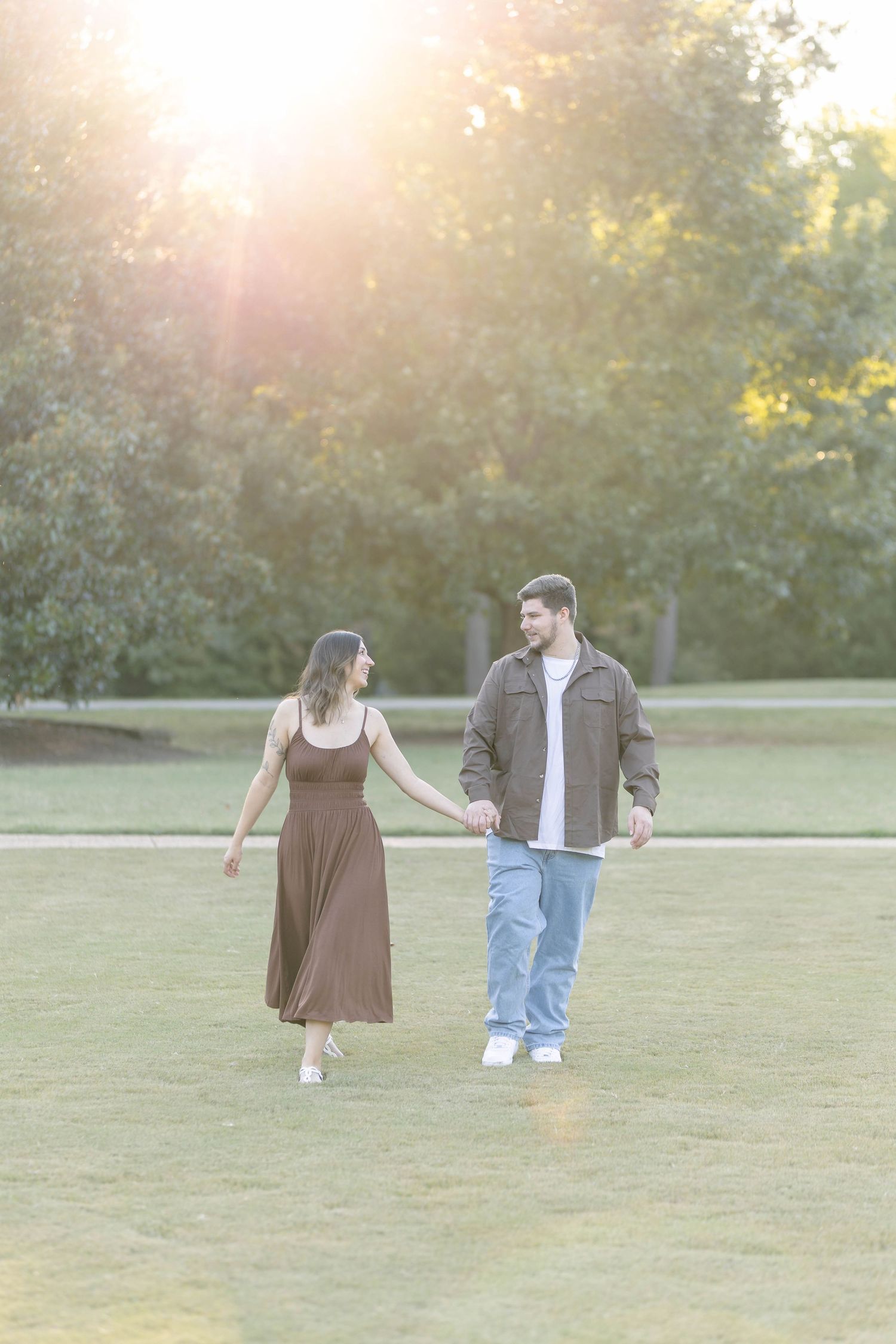 Couple holding hands during a golden hour photo session in wake forest north Carolina