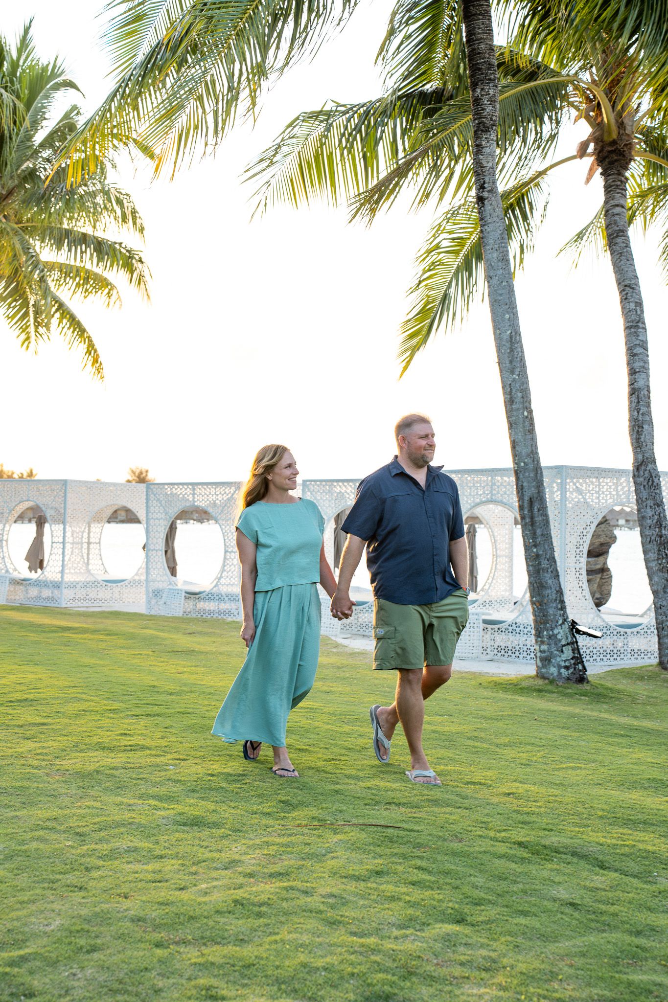 Couple photoshoot under palm trees on the beach in Bora Bora, French Polynesia