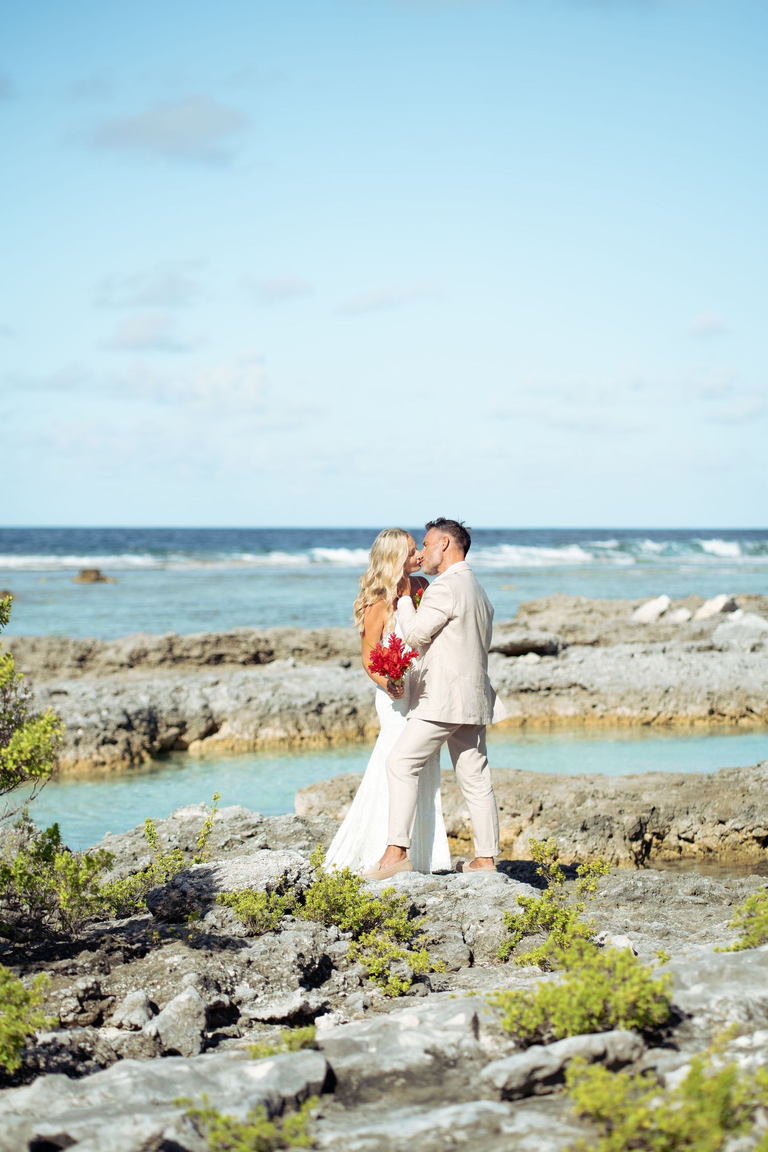 Bride and groom portrait by the ocean during their Bora Bora destination wedding