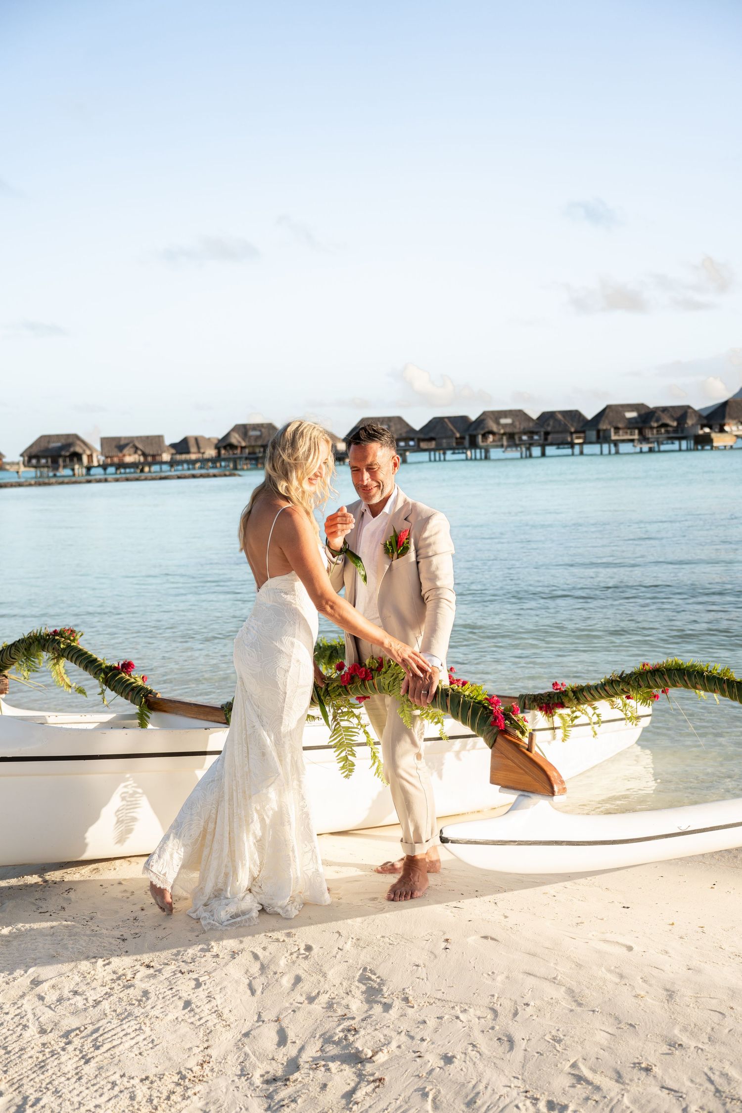 Newlywed couple celebrating their destination wedding by the Bora Bora lagoon