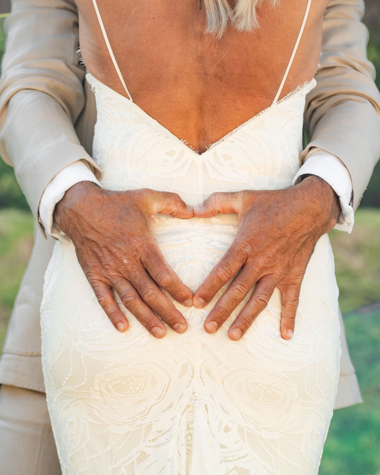 Close-up of bride and groom holding hands during their Bora Bora wedding