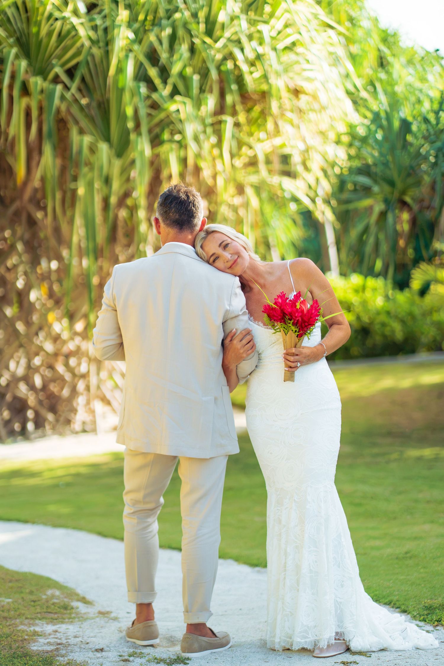 Newlywed couple walking through tropical gardens during their Bora Bora wedding