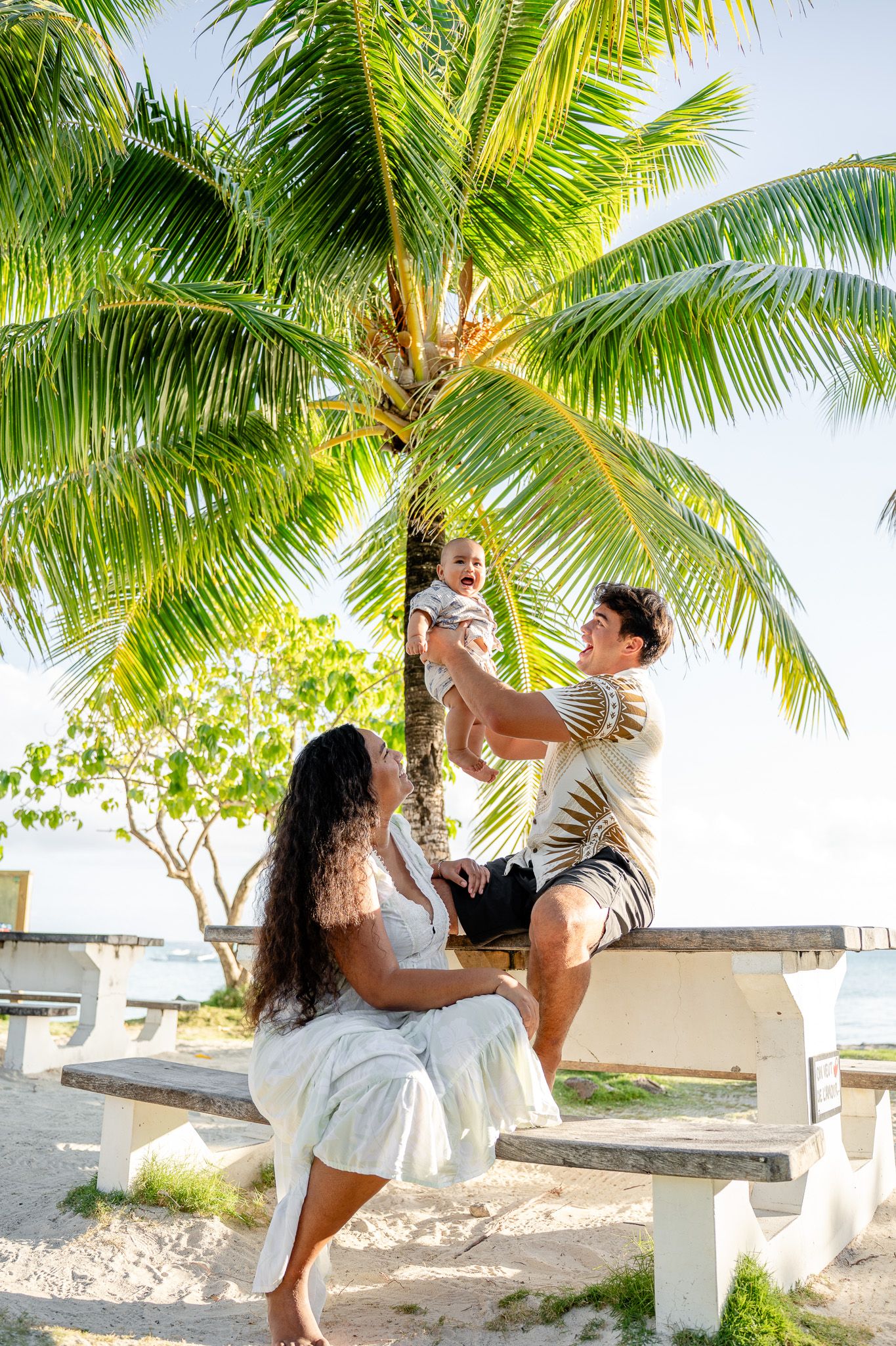 Mother and baby under palm trees during a family photoshoot in Bora Bora, French Polynesia