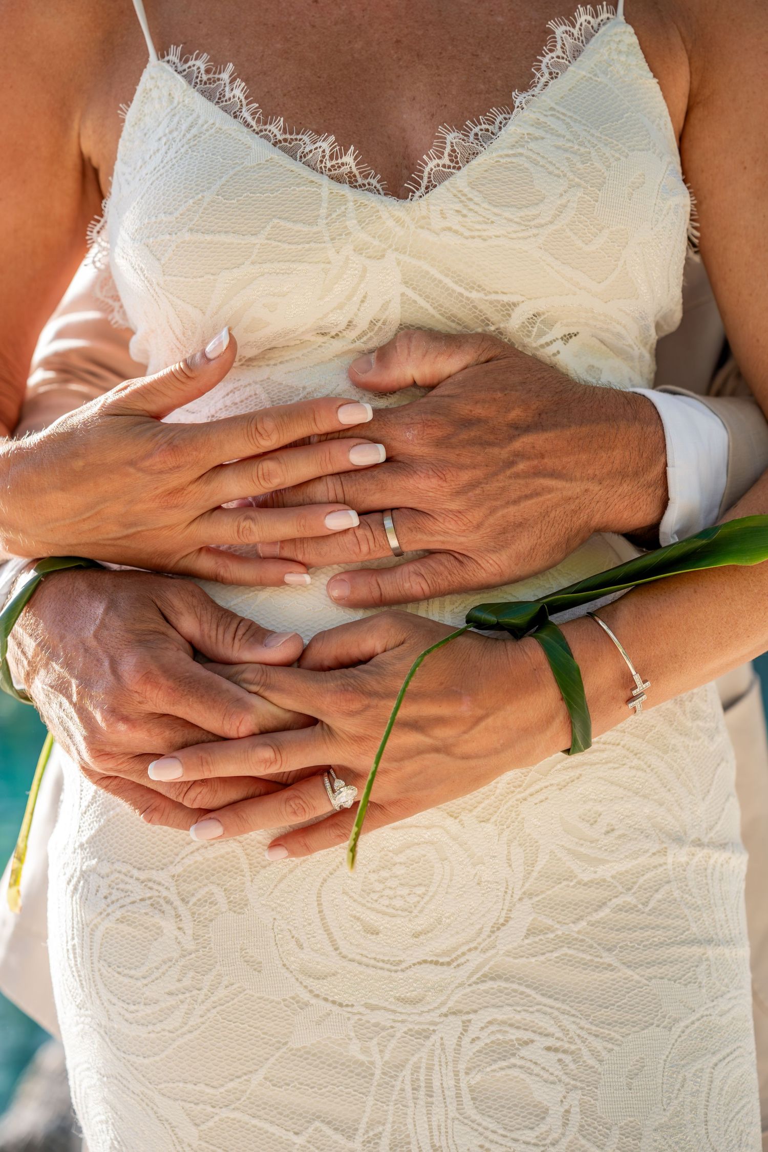Close-up of newlyweds holding hands during their Bora Bora wedding ceremony