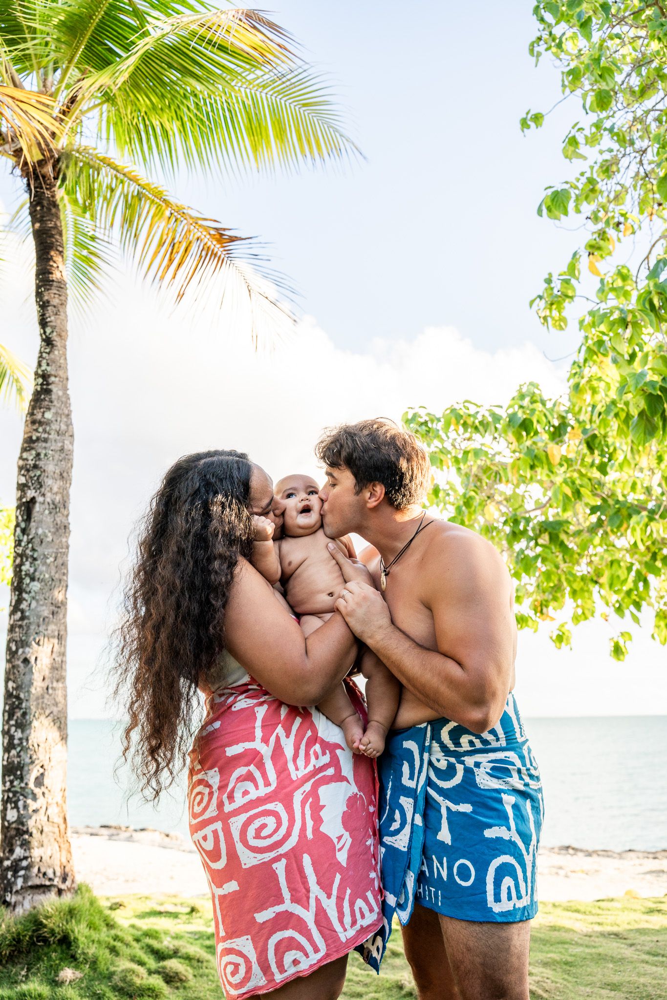 Family portrait under palm trees during a Bora Bora beach photoshoot