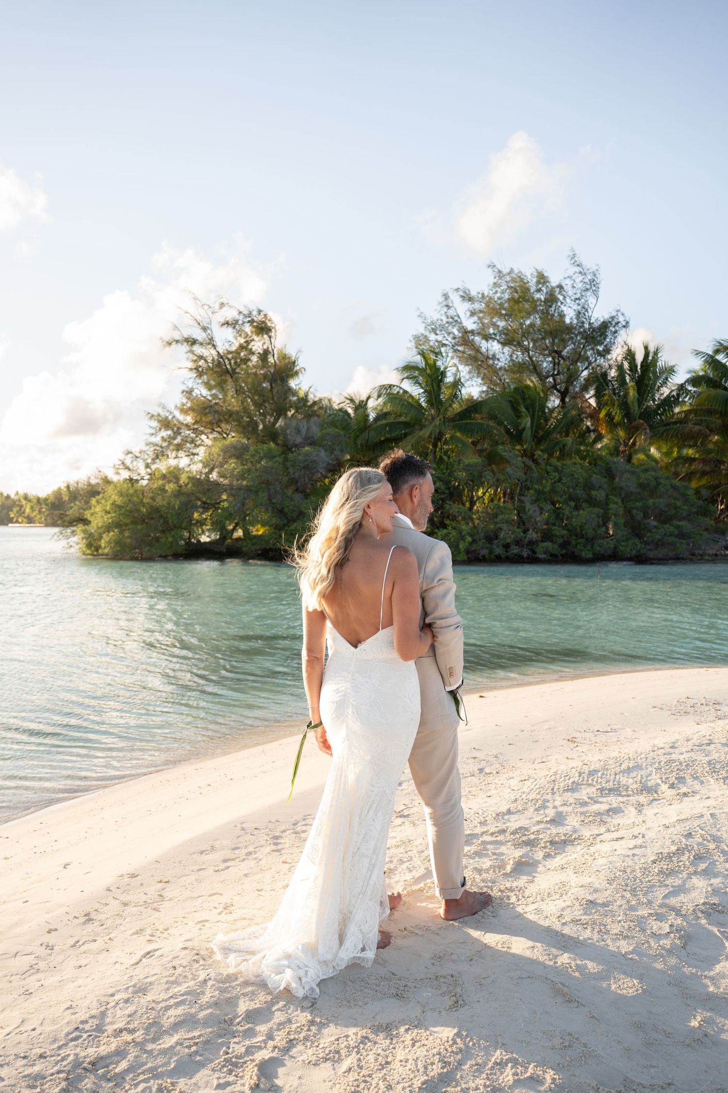Bride and groom embracing on the beach during their Bora Bora wedding