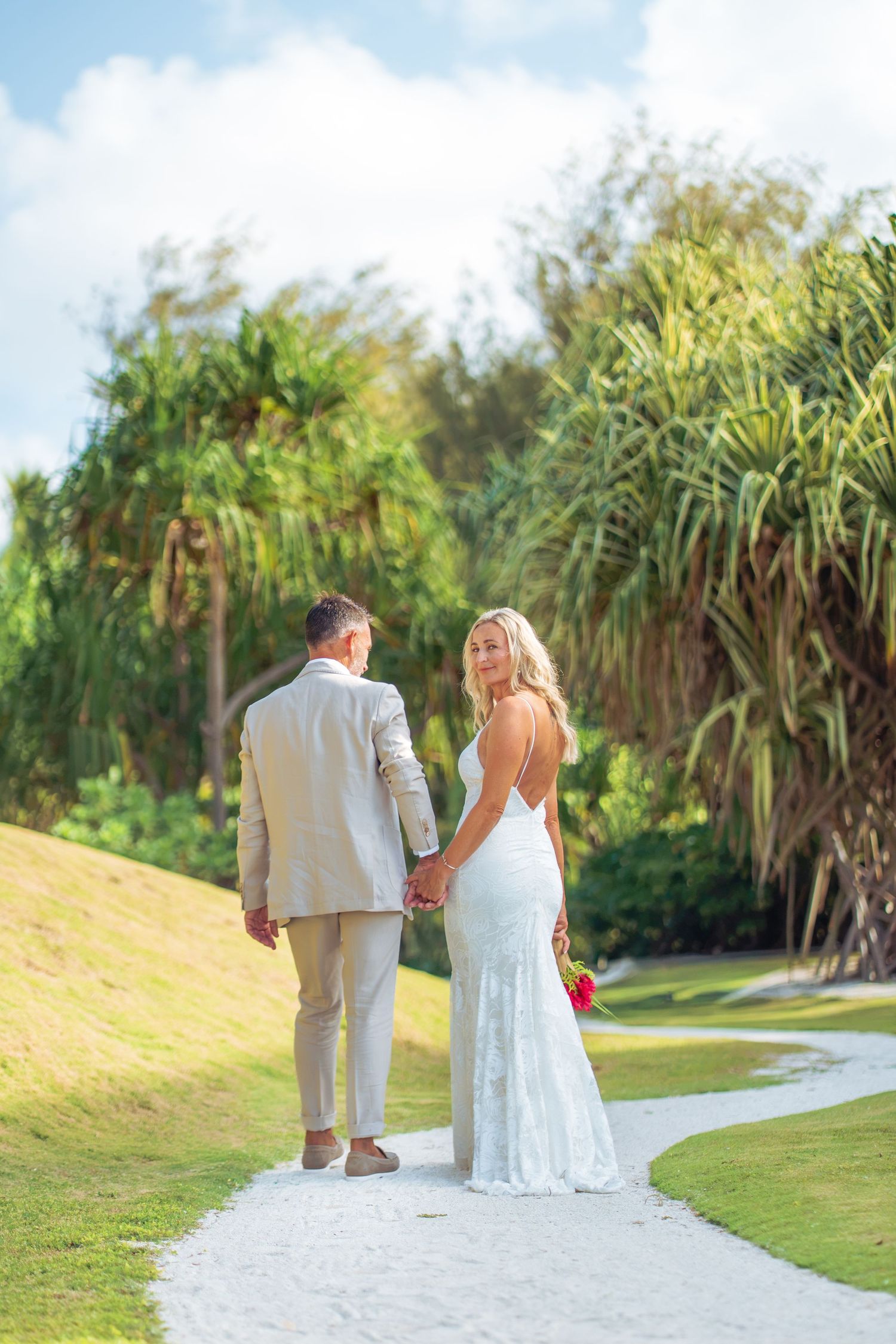 Bride and groom walking together during their tropical Bora Bora wedding