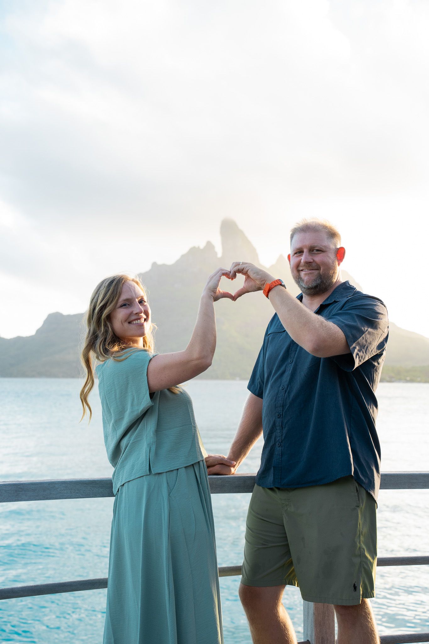 Couple enjoying a playful portrait session with Mount Otemanu in Bora Bora