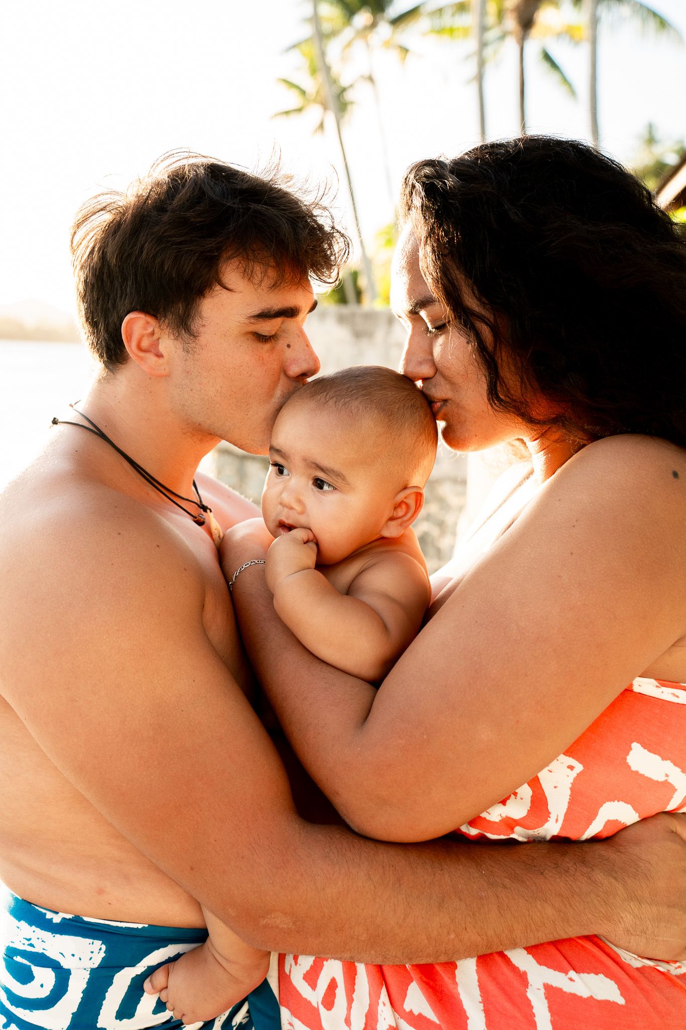 Parents with their baby during a family photoshoot in Bora Bora, French Polynesia