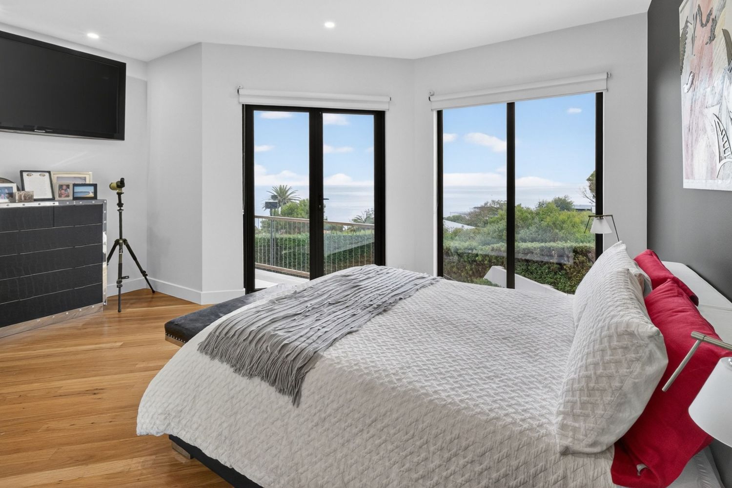 Master bedroom with soft natural light, calm styling, and modern interior design details.