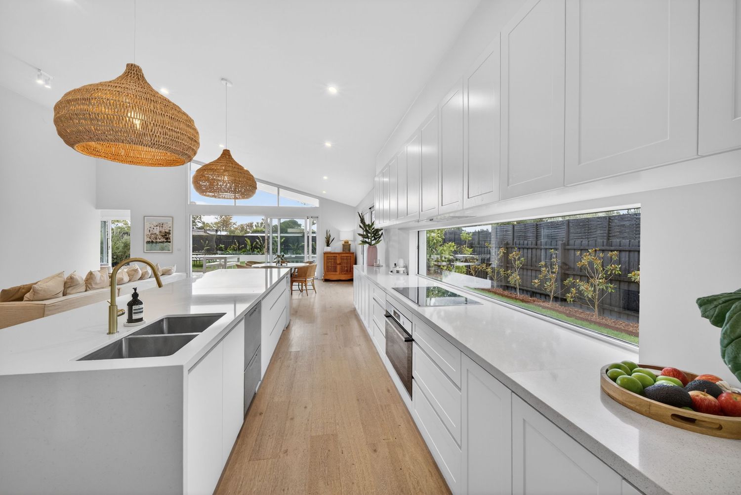 Long perspective shot down the length of a kitchen captured by BWImagery, highlighting clean lines, cabinetry, and cohesive interior design