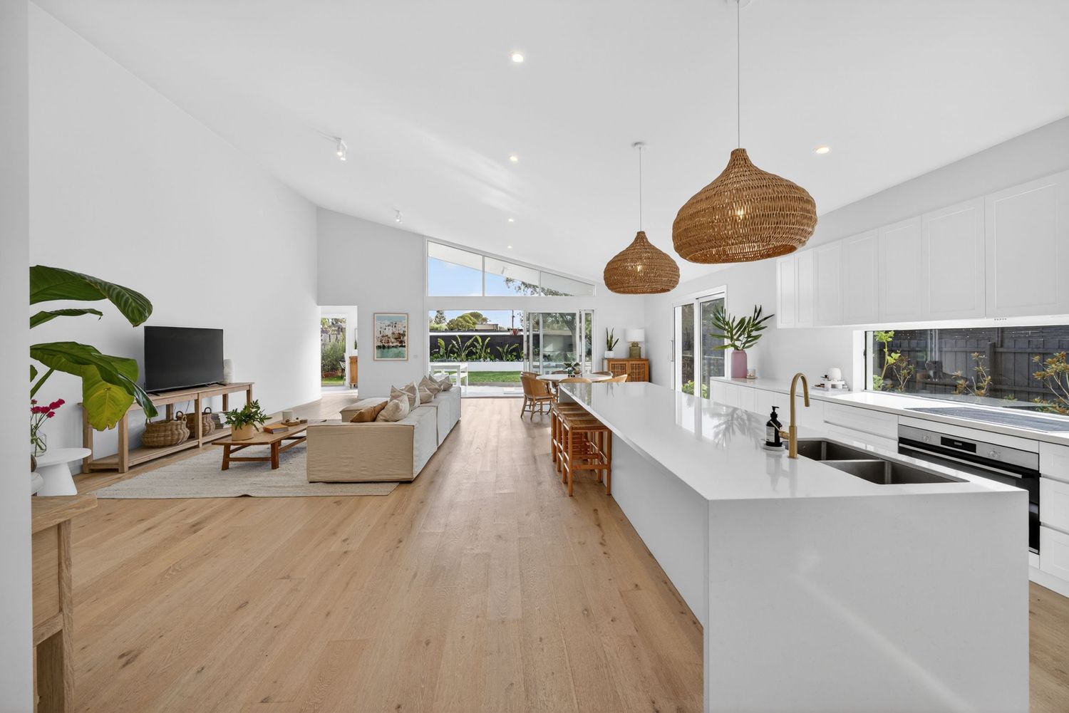 Long perspective shot down the length of a kitchen captured by BWImagery, highlighting clean lines, cabinetry, and cohesive interior design