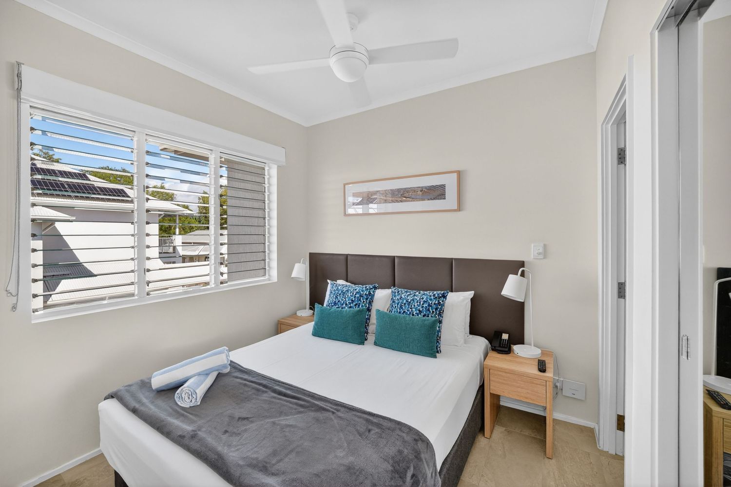Bedroom of a holiday apartment featuring relaxed, modern styling, soft natural light, and a calm, comfortable resort-inspired atmosphere.